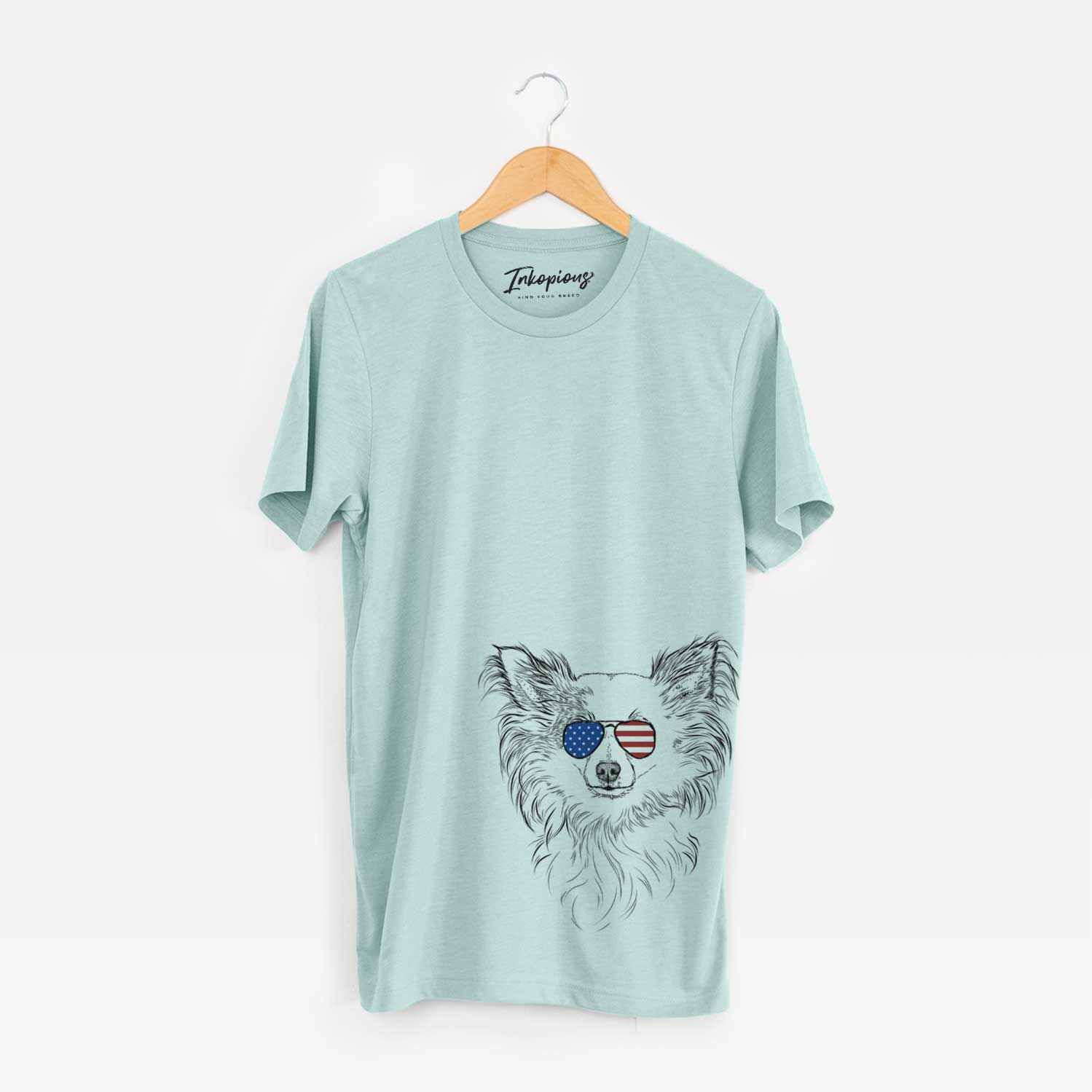 Hand-drawn sketch of Princess Ava the Long Haired Chihuahua wearing American flag sunglasses on a Heather Sage Unisex crewneck