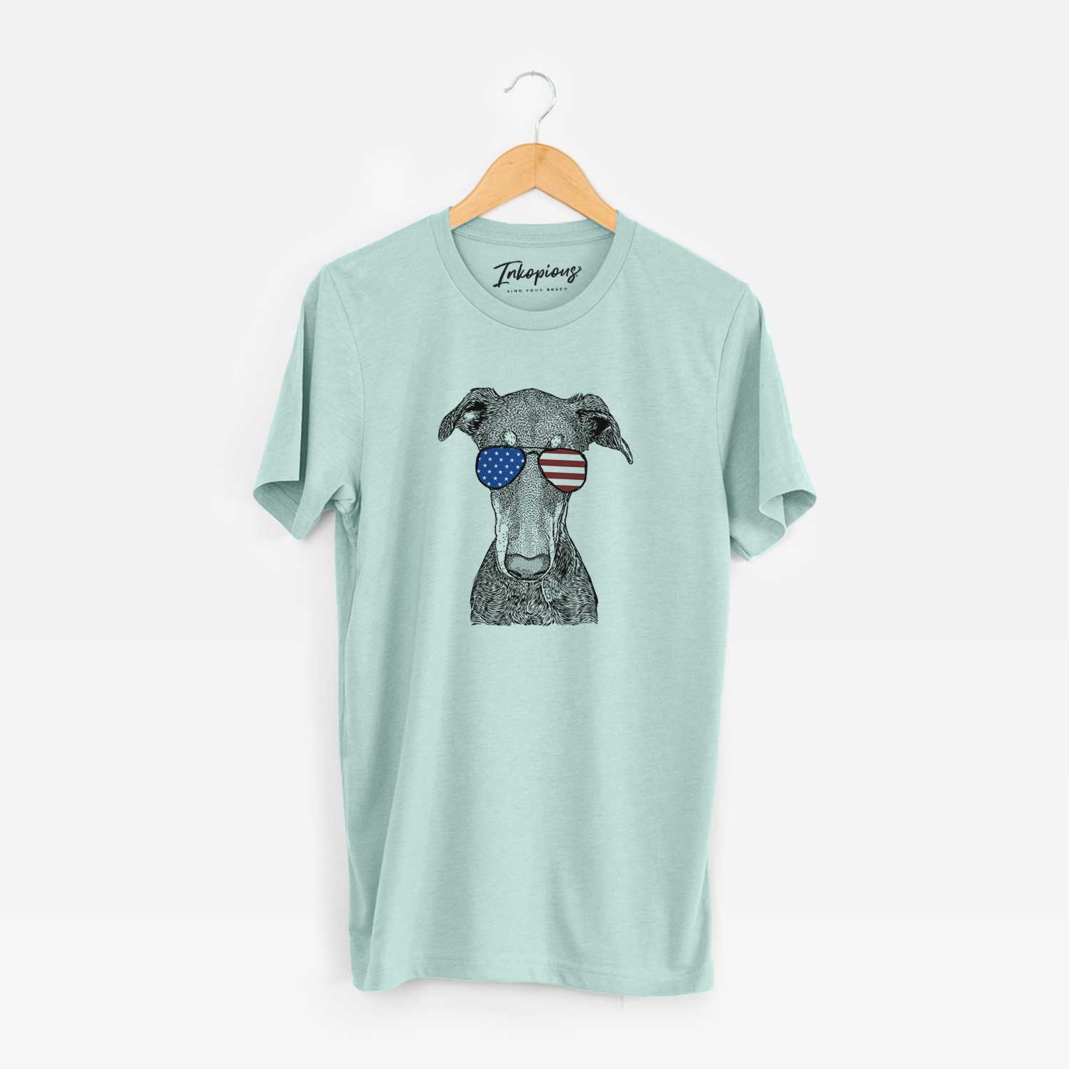 Hand-drawn sketch of Princess Fiona the Doberman Pinscher wearing American flag sunglasses on a Heather Sage Unisex crewneck