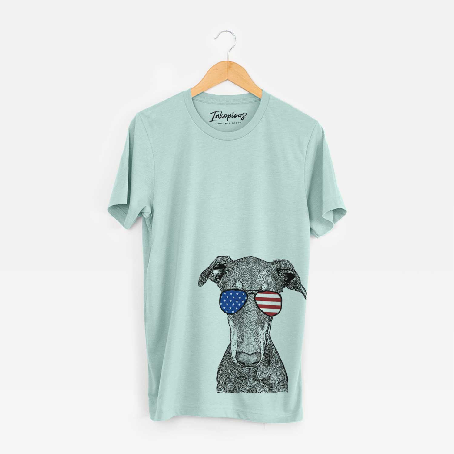 Hand-drawn sketch of Princess Fiona the Doberman Pinscher wearing American flag sunglasses on a Heather Sage Unisex crewneck