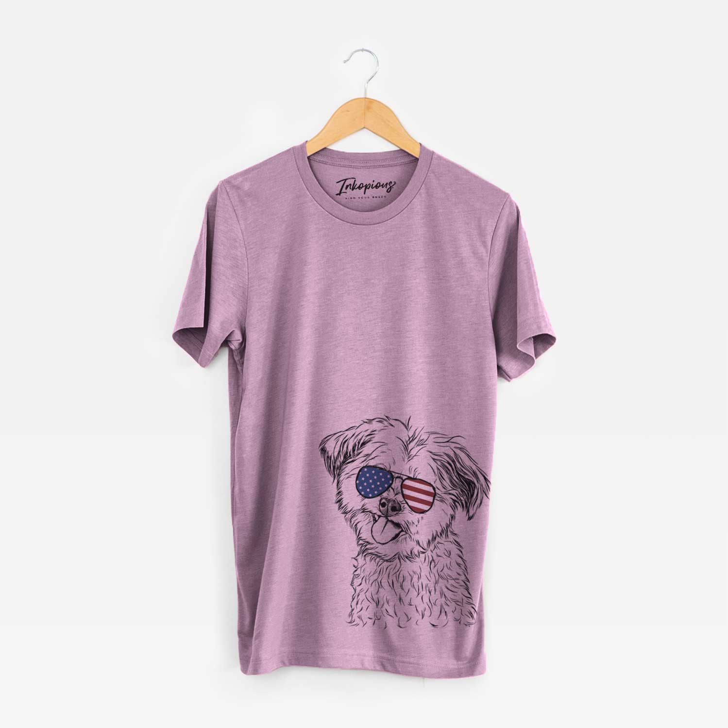 Hand-drawn sketch of Puff the Malshi wearing American flag sunglasses on an Orchid Unisex crewneck