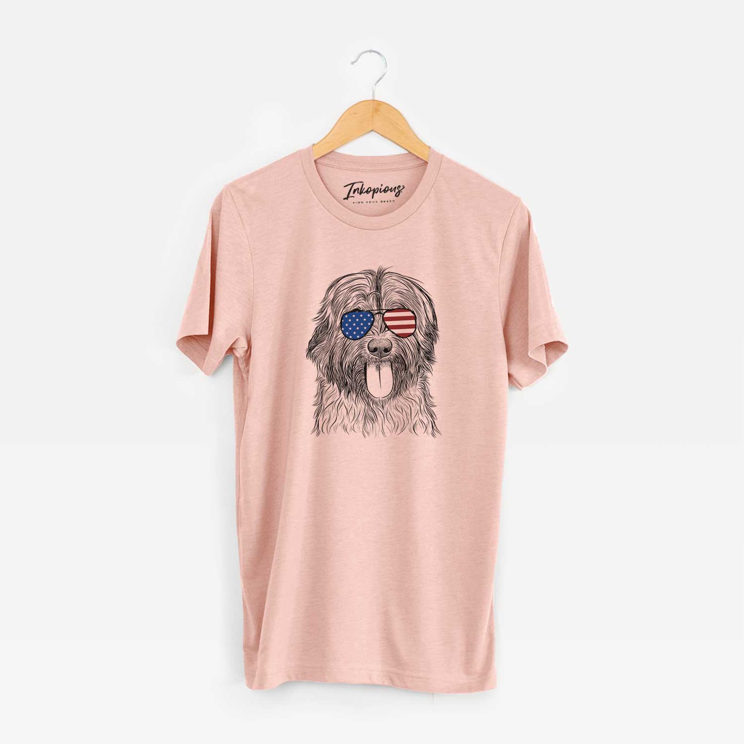Hand-drawn sketch of Puig the Catalan Sheepdog wearing American flag sunglasses on a Peach Unisex crewneck