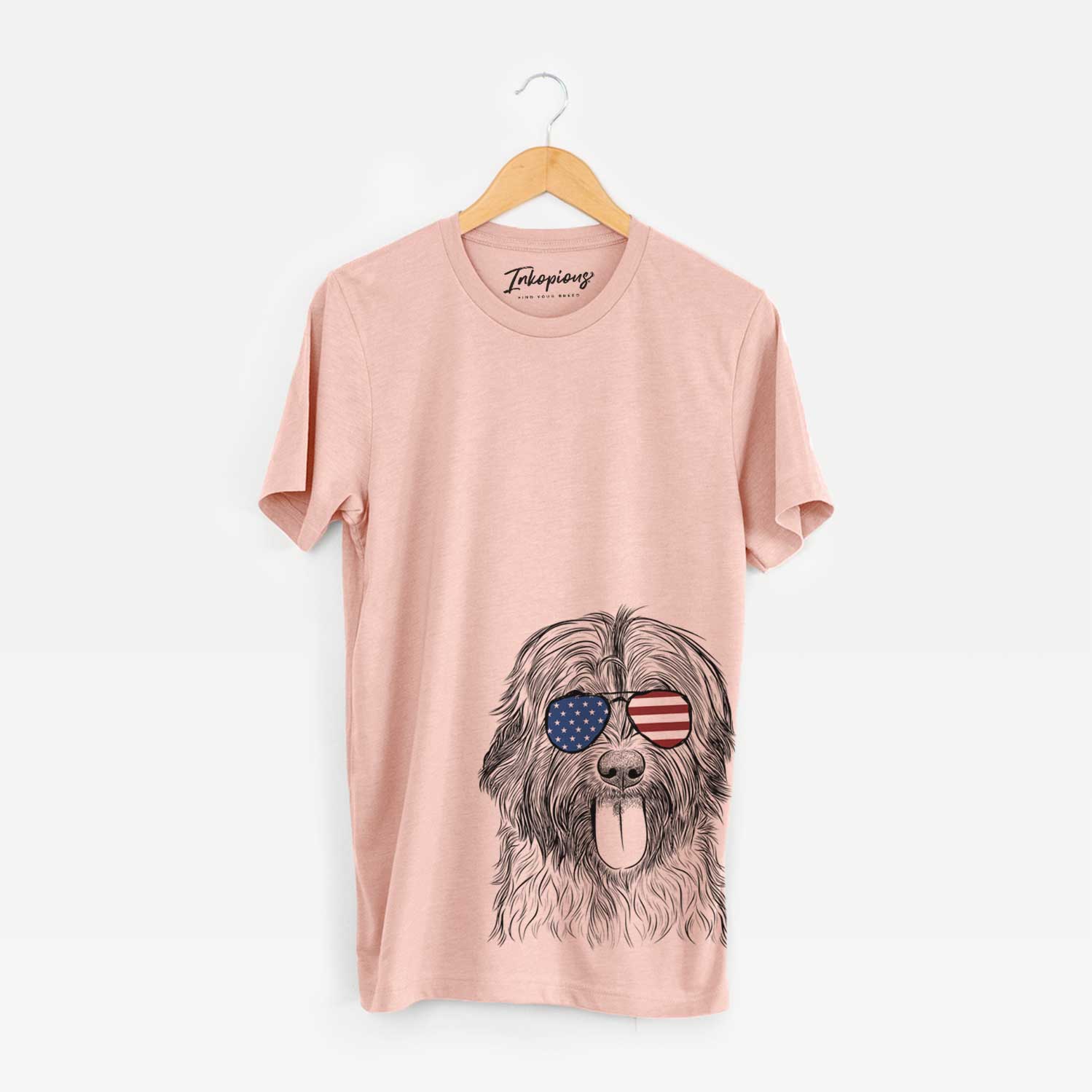Hand-drawn sketch of Puig the Catalan Sheepdog wearing American flag sunglasses on a Peach Unisex crewneck