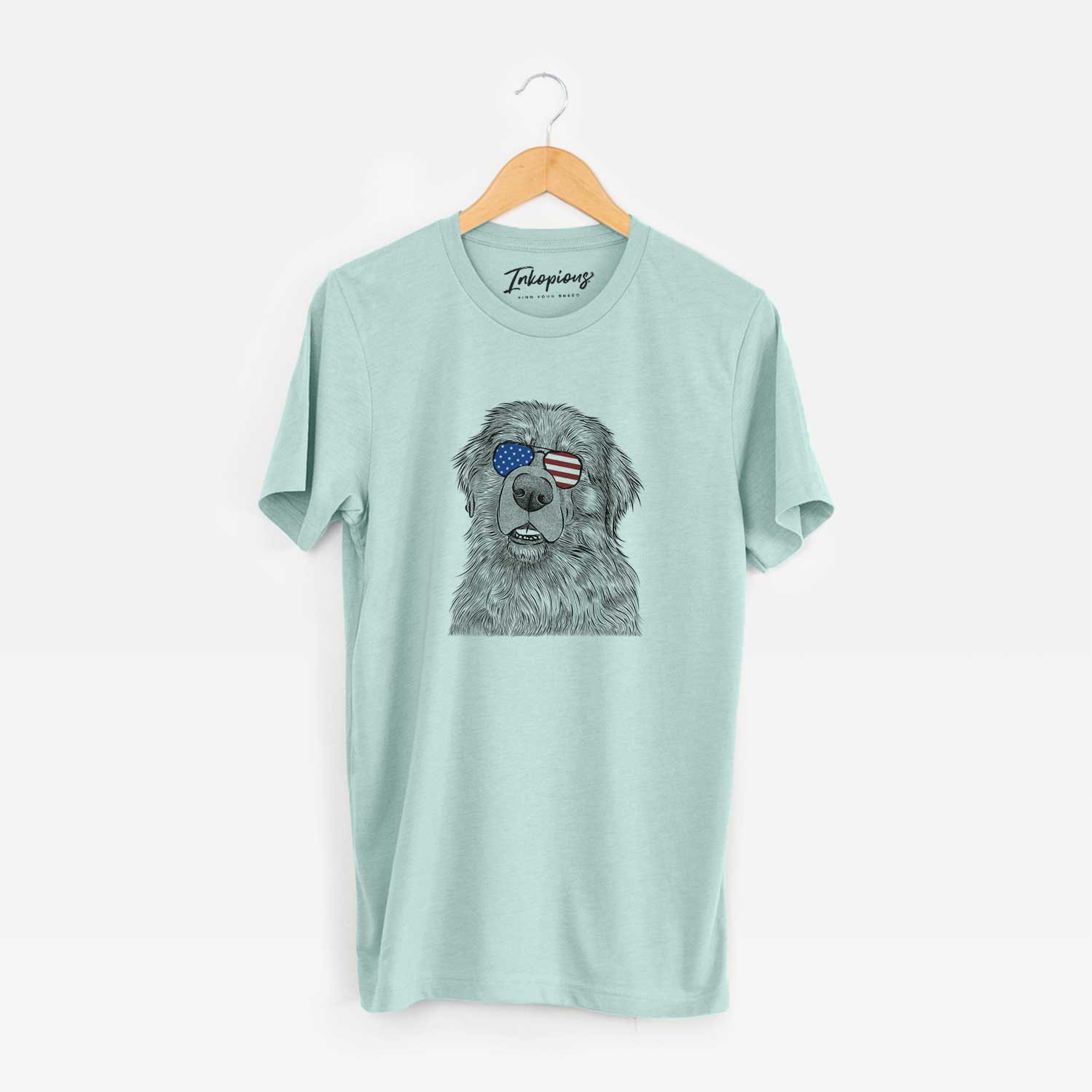 Hand-drawn sketch of Ralph the Leonberger wearing American flag sunglasses on a Heather Sage Unisex crewneck
