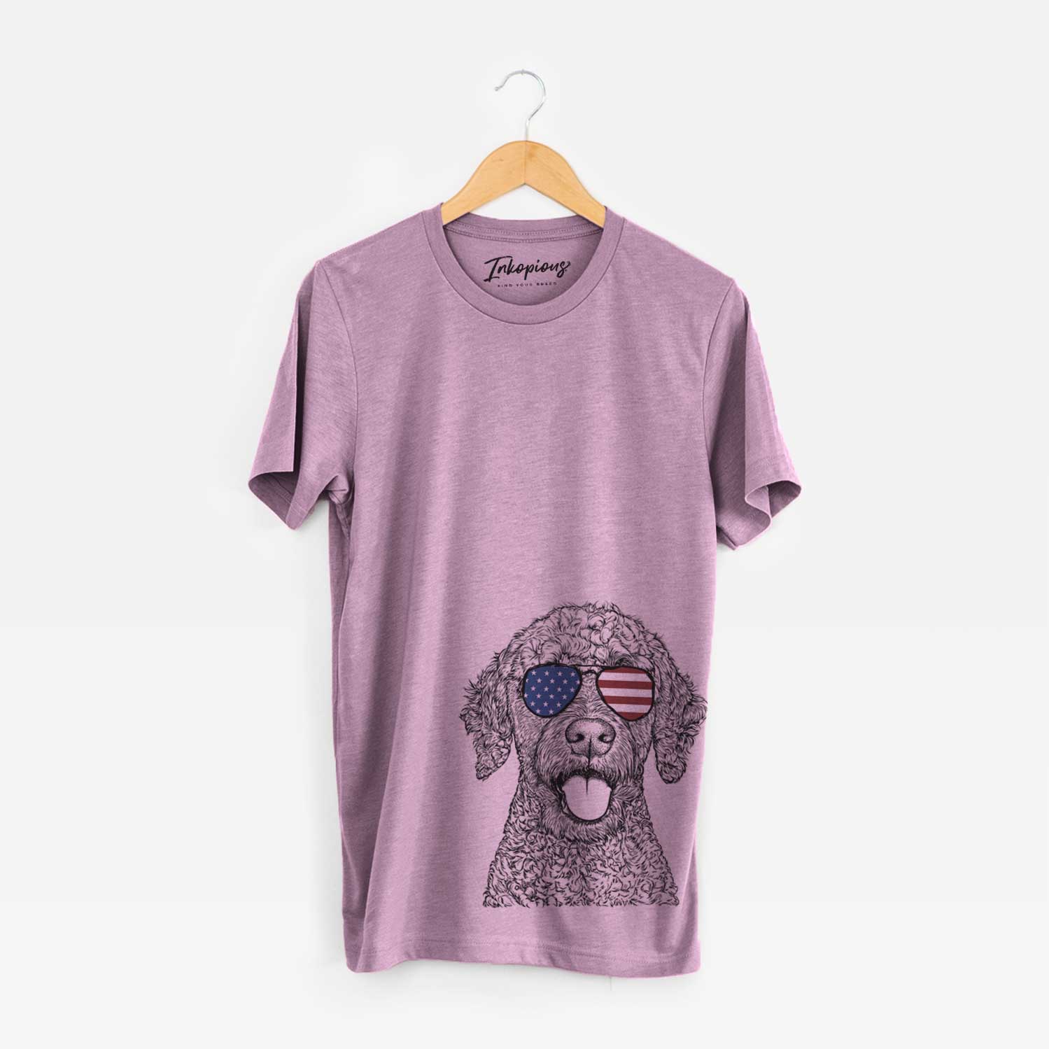Hand-drawn sketch of Reina the Spanish Water Dog wearing American flag sunglasses on an Orchid Unisex crewneck