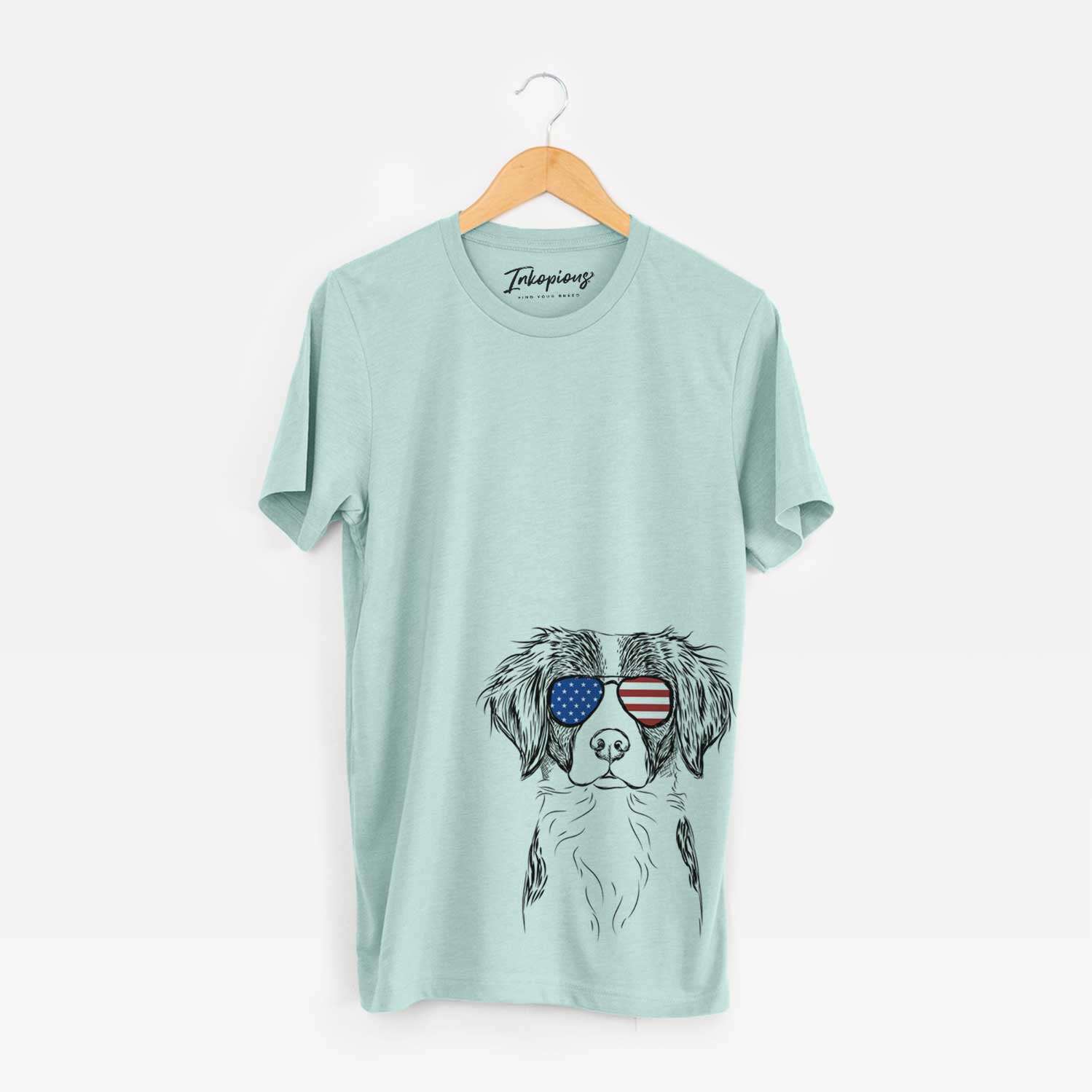 Hand-drawn sketch of Remi the Brittany wearing American flag sunglasses on a Heather Sage Unisex crewneck