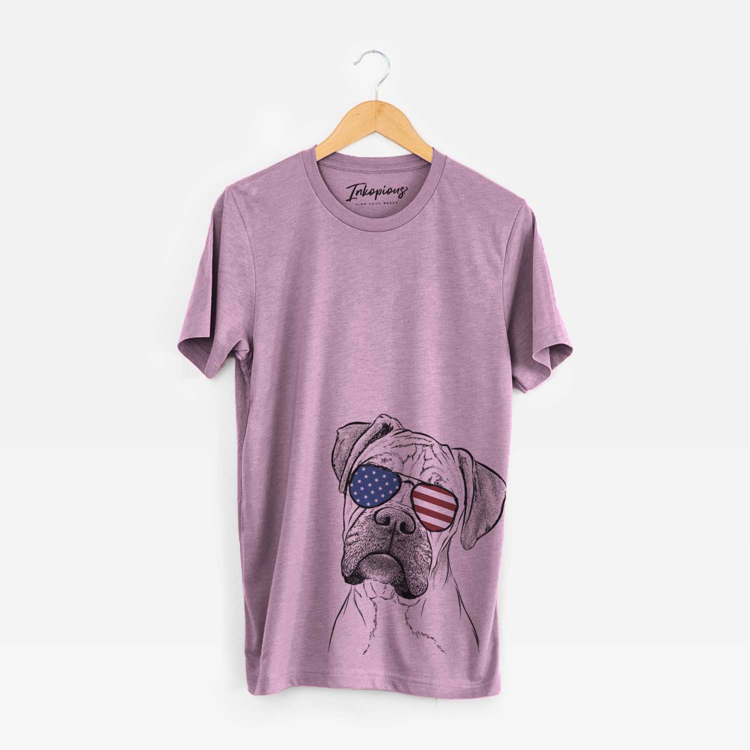 Hand-drawn sketch of Reuby the Boxer wearing American flag sunglasses on an Orchid Unisex crewneck