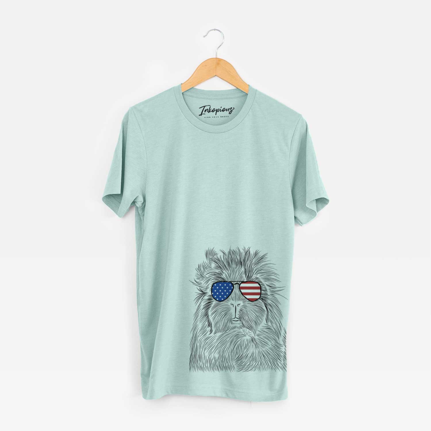 Hand-drawn sketch of Rhino the Guinea Pig wearing American flag sunglasses on a Heather Sage Unisex crewneck