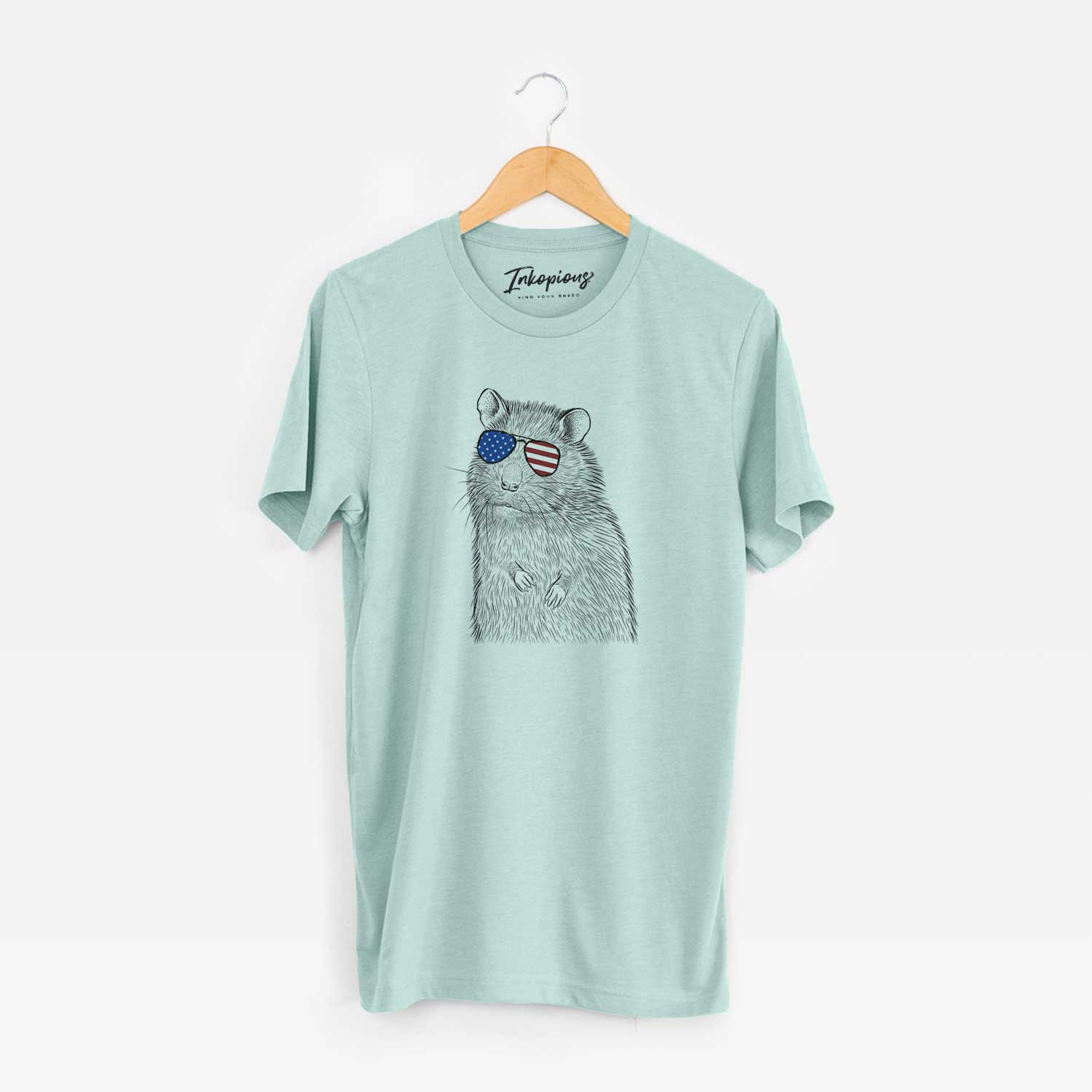 Hand-drawn sketch of Rizzo the Rat wearing American flag sunglasses on a Heather Sage Unisex crewneck
