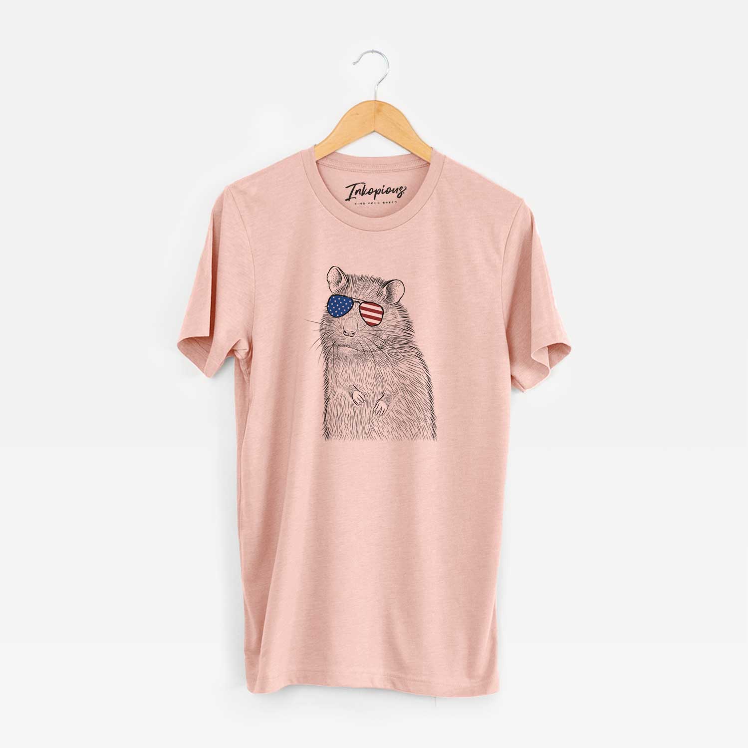 Hand-drawn sketch of Rizzo the Rat wearing American flag sunglasses on a Peach Unisex crewneck