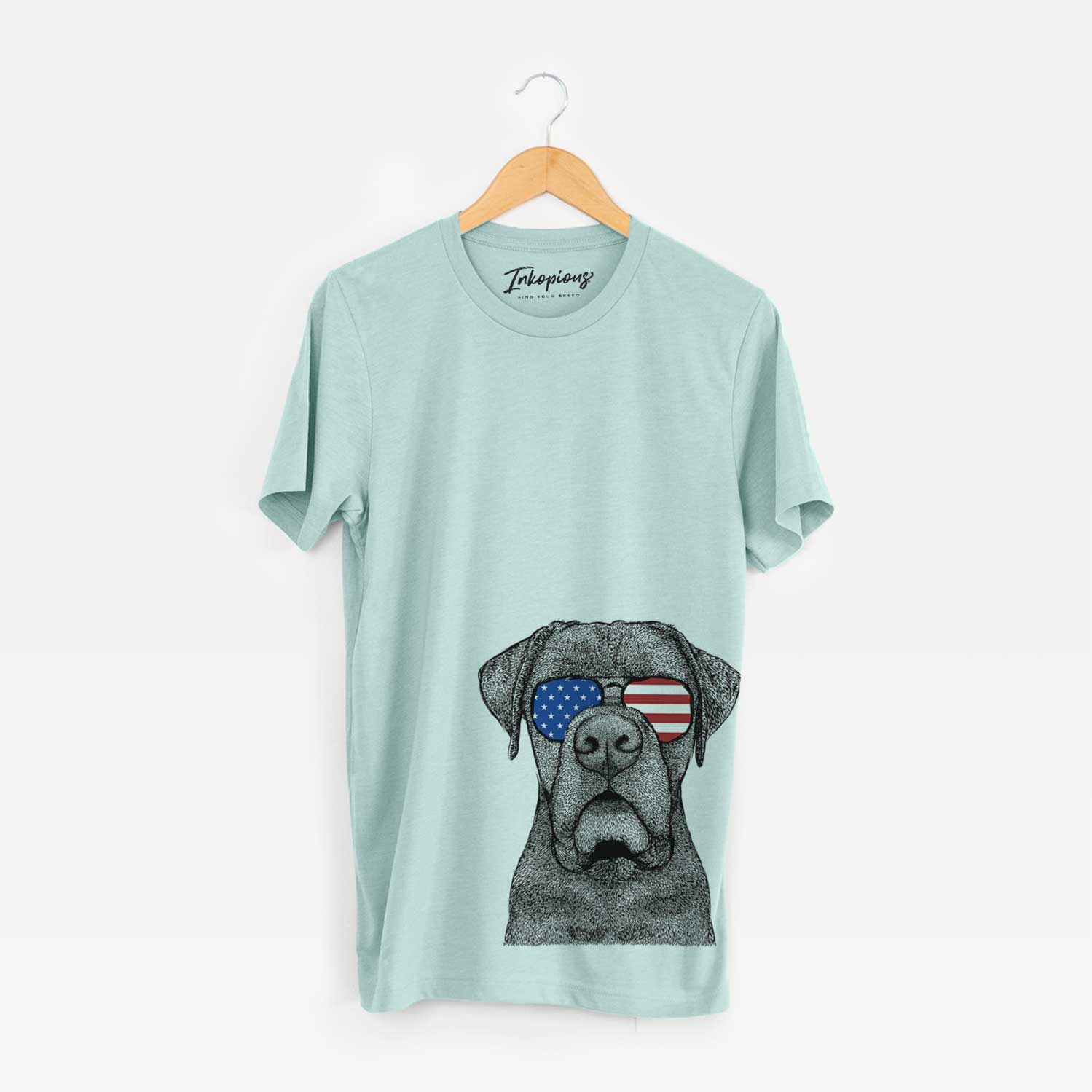 Hand-drawn sketch of Rocco the Cane Corso wearing American flag sunglasses on a Heather Sage Unisex crewneck