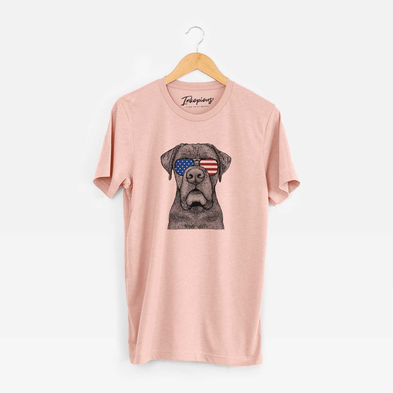 Hand-drawn sketch of Rocco the Cane Corso wearing American flag sunglasses on a Peach Unisex crewneck