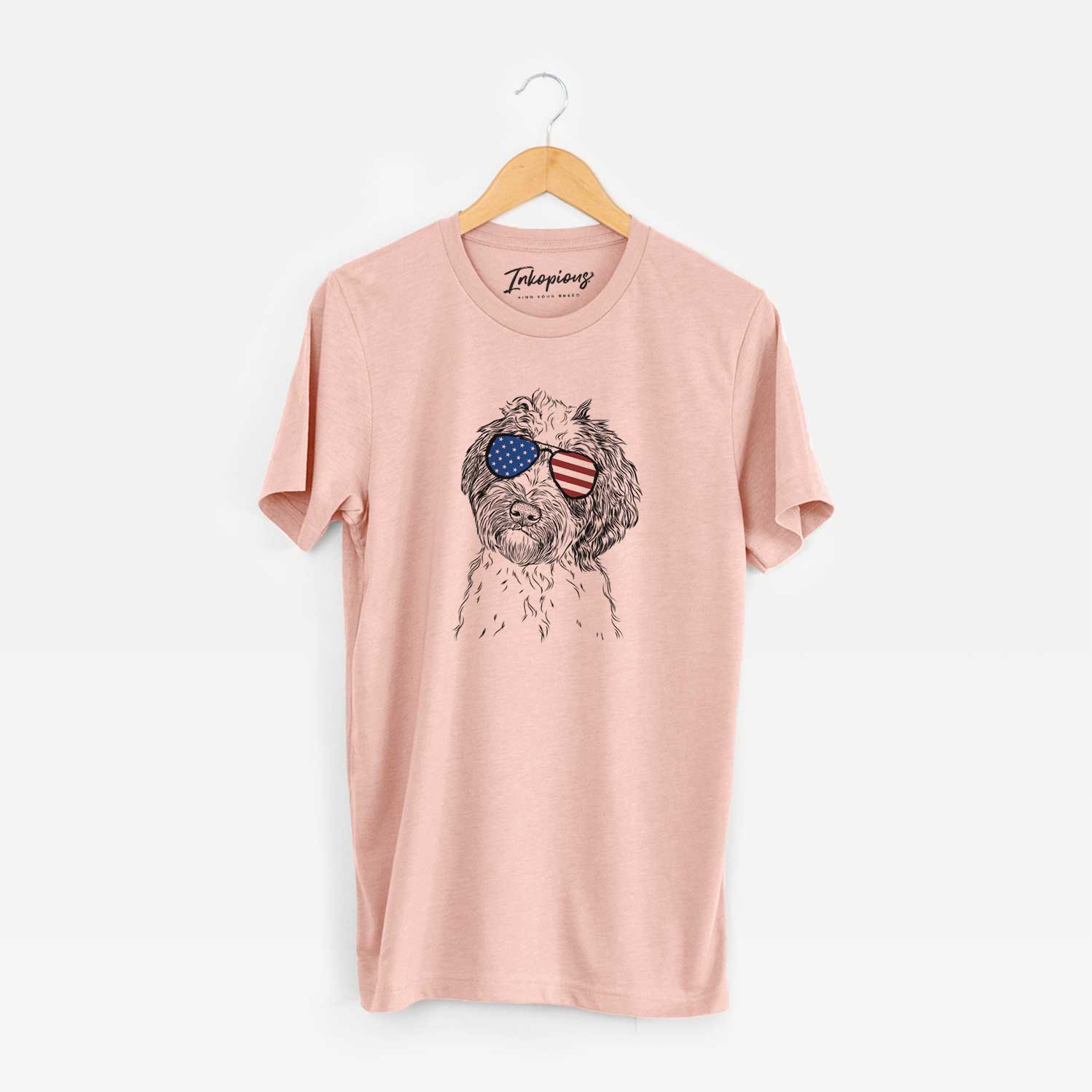 Hand-drawn sketch of Rooney the Aussiedoodle wearing American flag sunglasses on a Peach Unisex crewneck