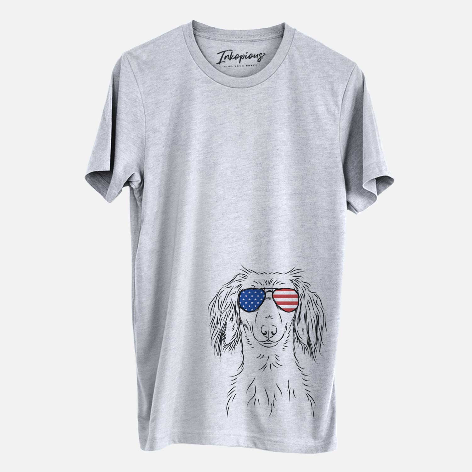 Hand-drawn sketch of Roux the Long Haired Dachshund wearing American flag sunglasses on a Grey Unisex crewneck