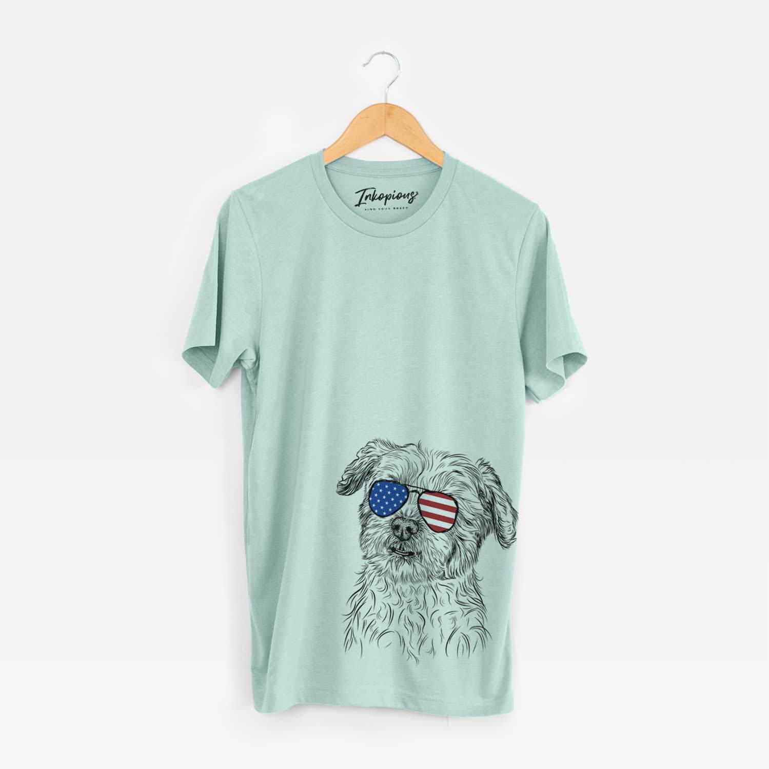 Hand-drawn sketch of Roxie the Schnauzer Shih Tzu Mix wearing American flag sunglasses on a Heather Sage Unisex crewneck