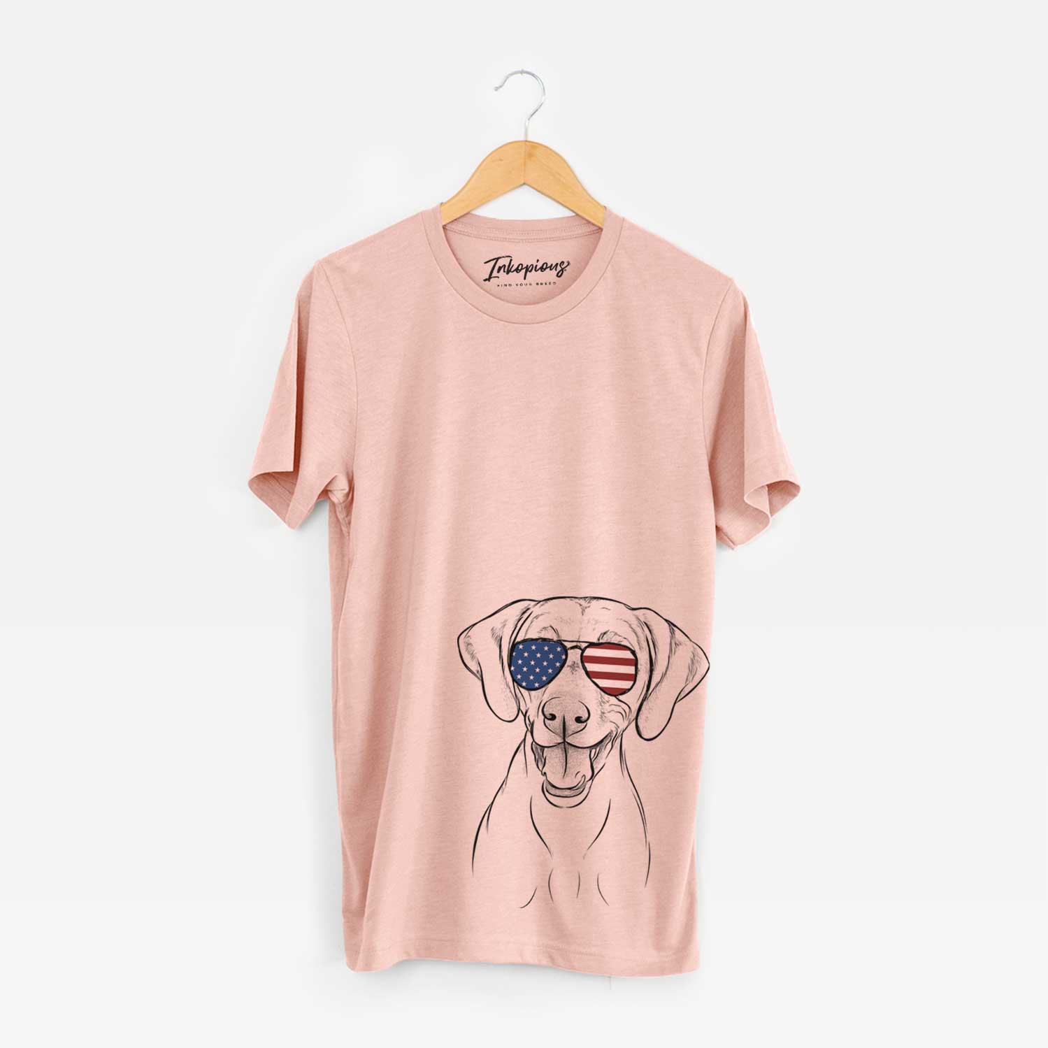 Hand-drawn sketch of Ruby the Vizsla wearing American flag sunglasses on a Peach Unisex crewneck