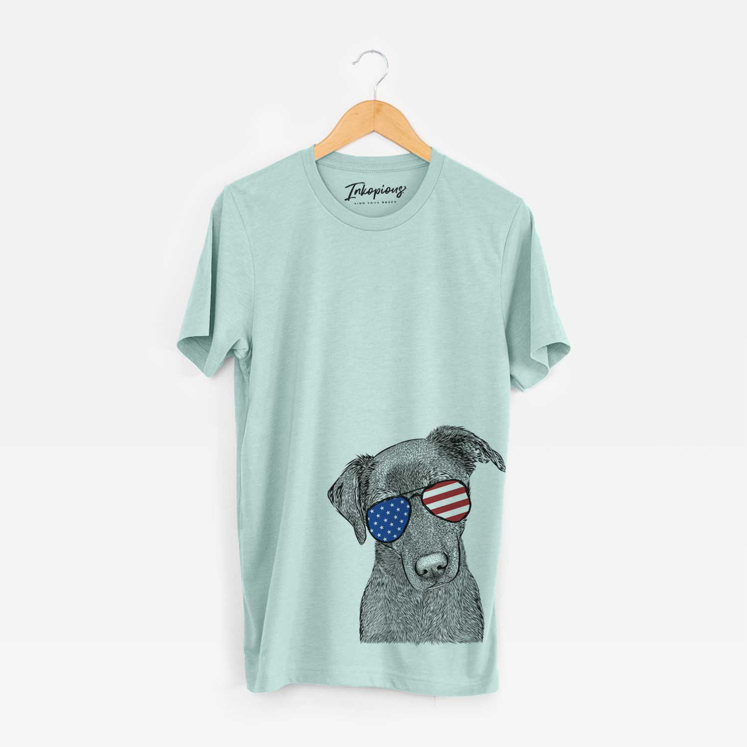 Hand-drawn sketch of Sadie the Whipador wearing American flag sunglasses on a Heather Sage Unisex crewneck
