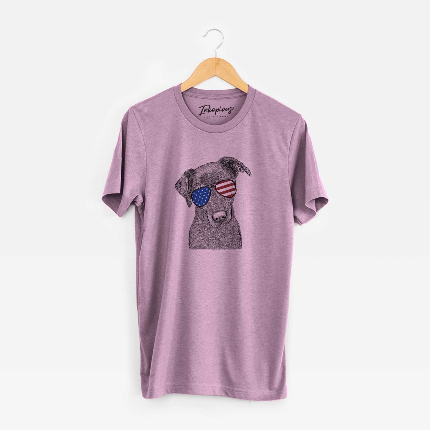 Hand-drawn sketch of Sadie the Whipador wearing American flag sunglasses on an Orchid Unisex crewneck