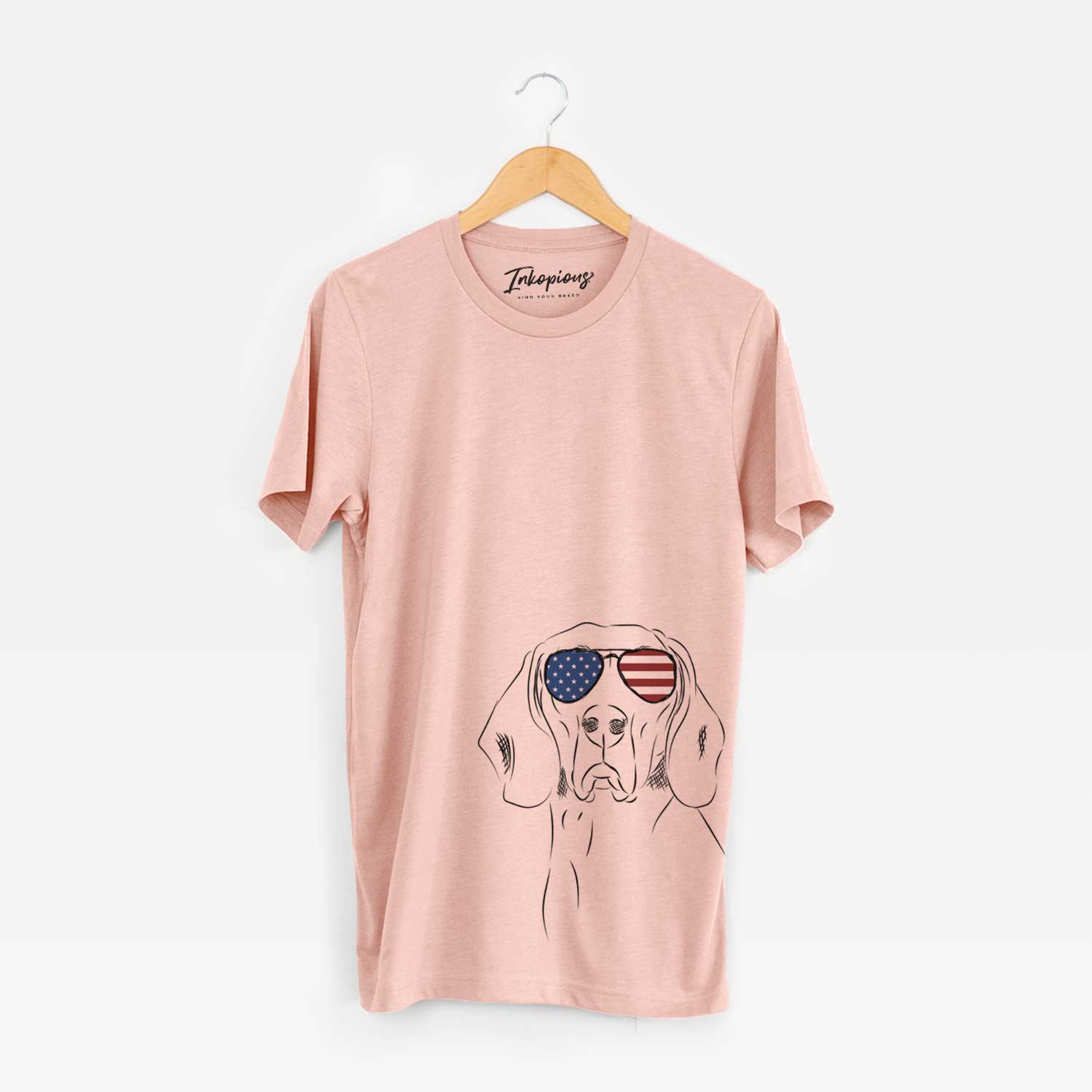Hand-drawn sketch of Sagan the Coonhound wearing American flag sunglasses on a Peach Unisex crewneck