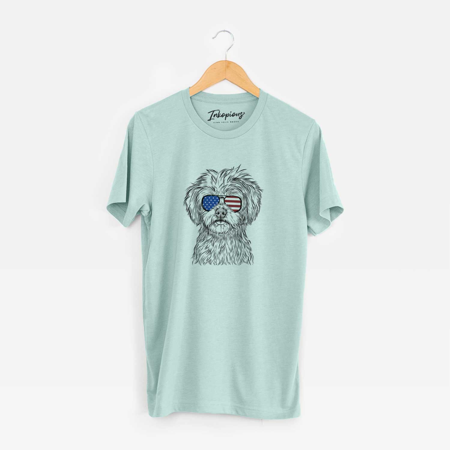 Hand-drawn sketch of Sammy the Shorkie wearing American flag sunglasses on a Heather Sage Unisex crewneck