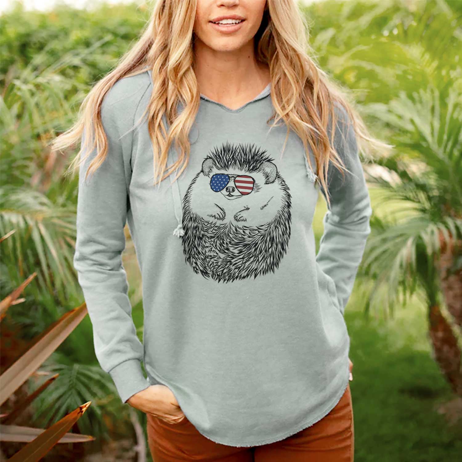 Hand-drawn sketch of Sid the Hedgehog wearing American flag sunglasses on a Sage Cali Wave Hooded Sweatshirt, lifestyle photo