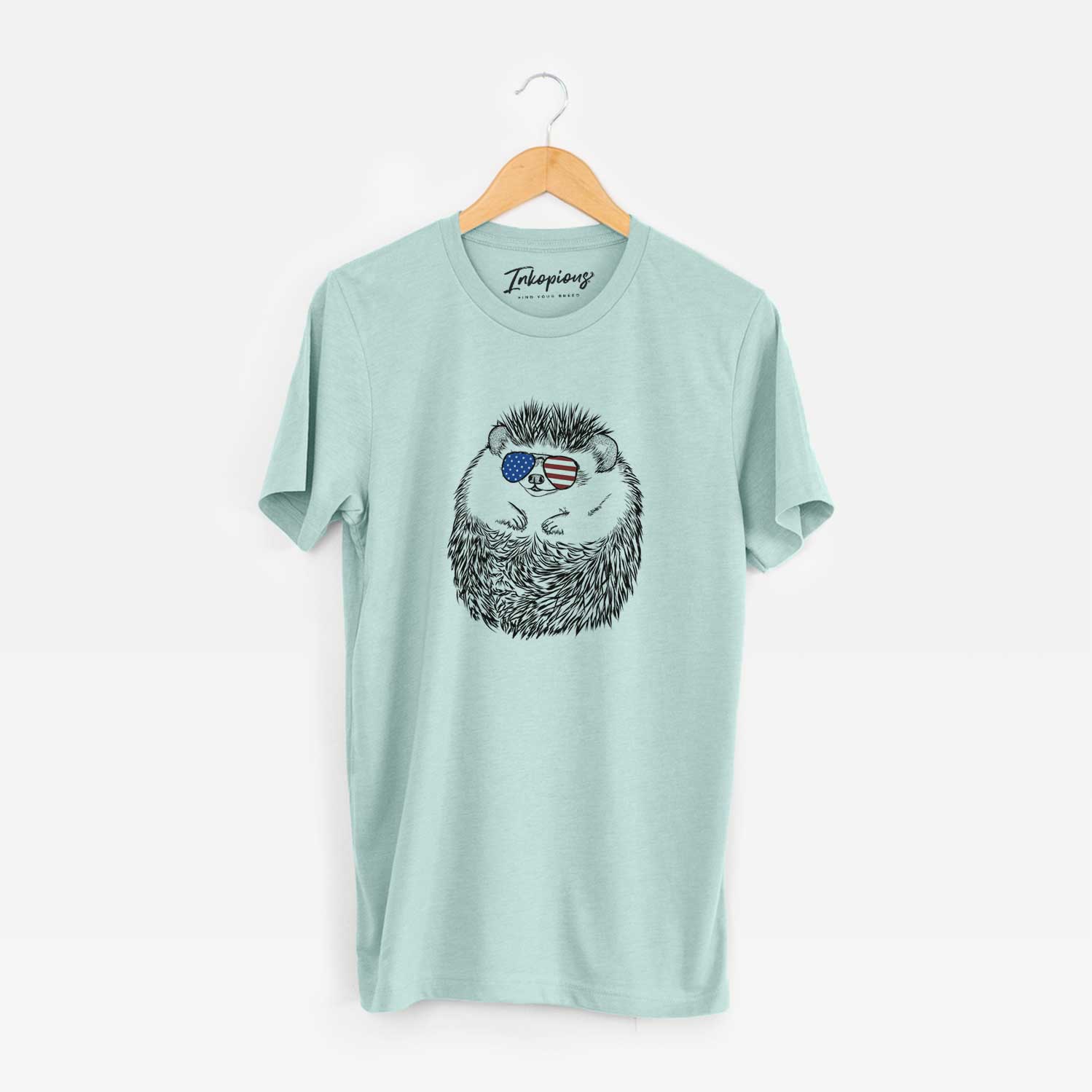 Hand-drawn sketch of Sid the Hedgehog wearing American flag sunglasses on a Heather Sage Unisex crewneck