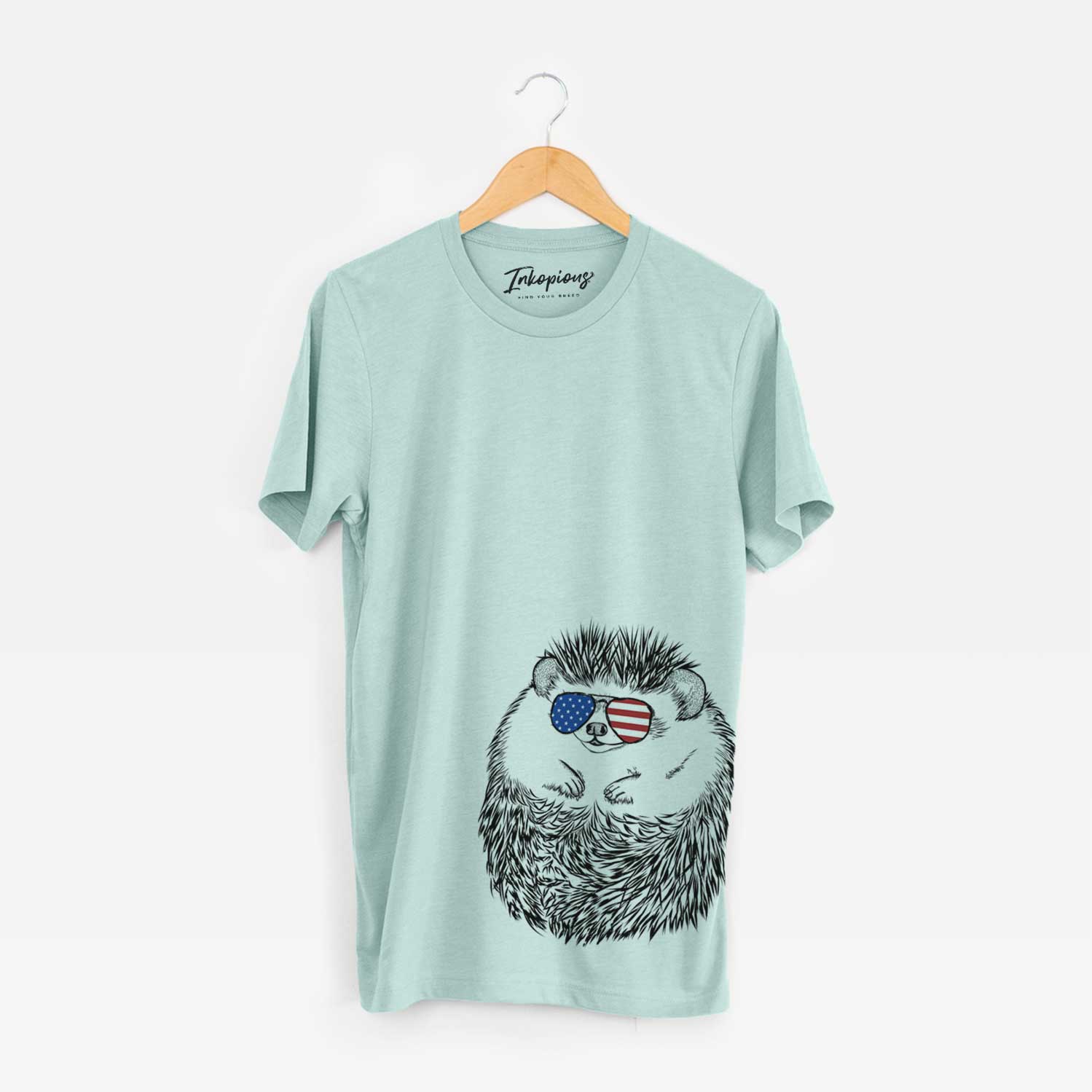 Hand-drawn sketch of Sid the Hedgehog wearing American flag sunglasses on a Heather Sage Unisex crewneck