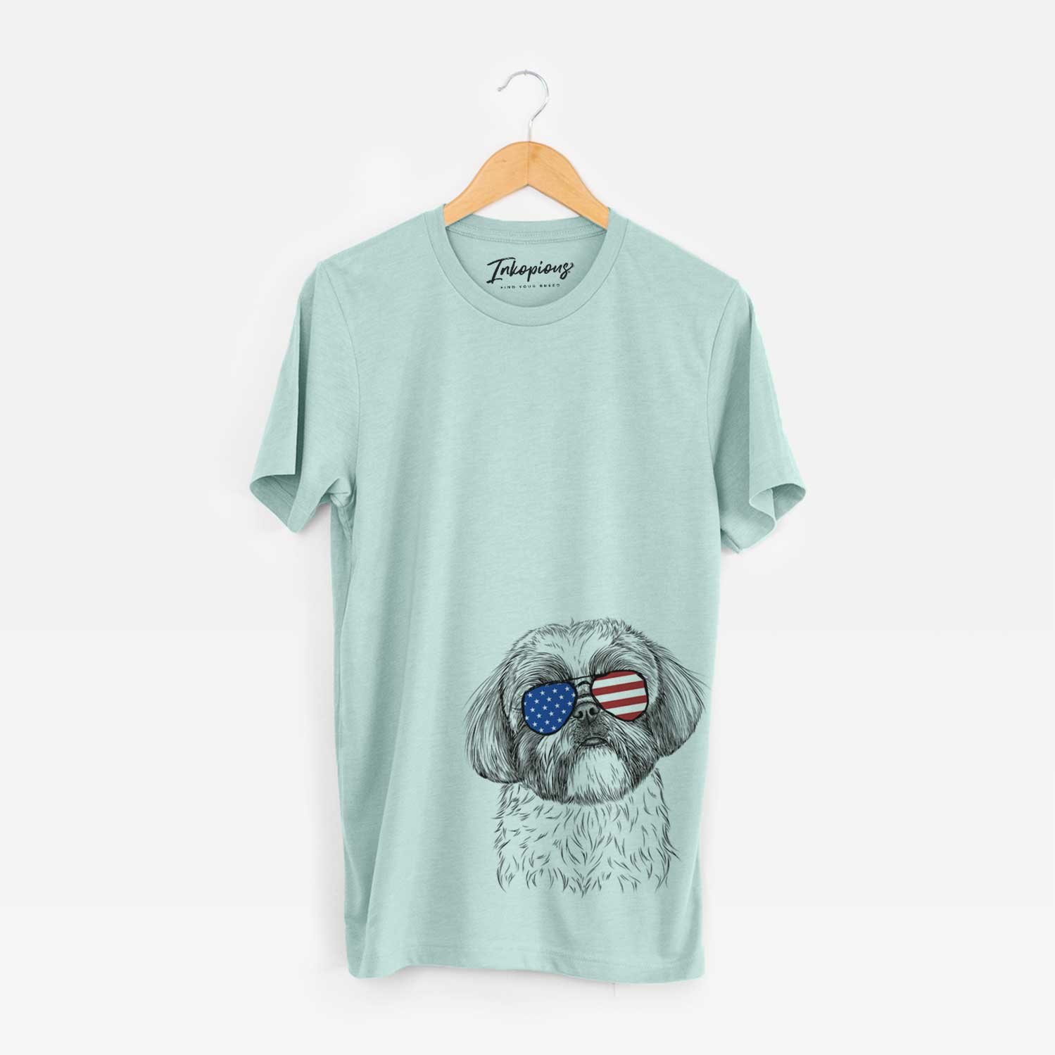 Hand-drawn sketch of Simon the Shih Tzu wearing American flag sunglasses on a Heather Sage Unisex crewneck