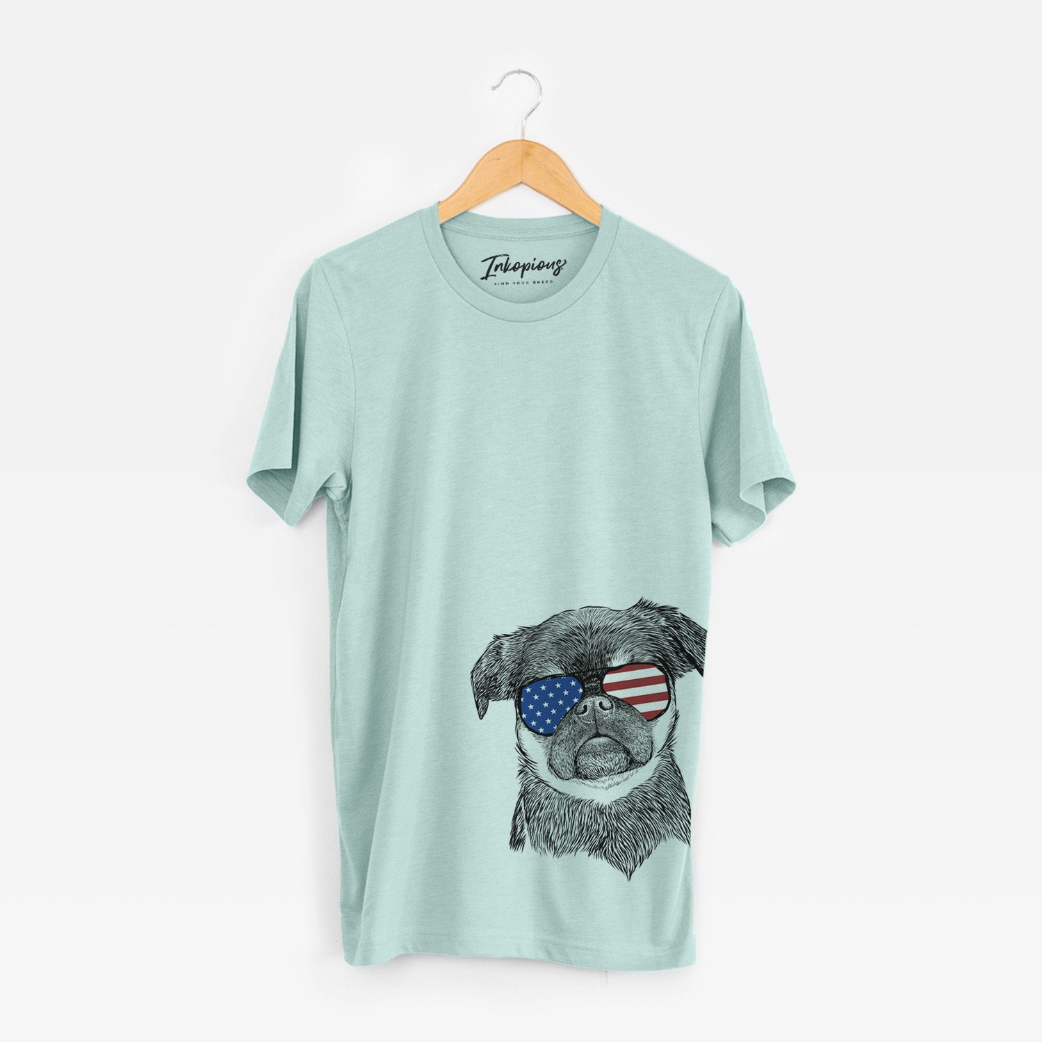 Hand-drawn sketch of Simone the Brussels Griffon wearing American flag sunglasses on a Heather Sage Unisex crewneck