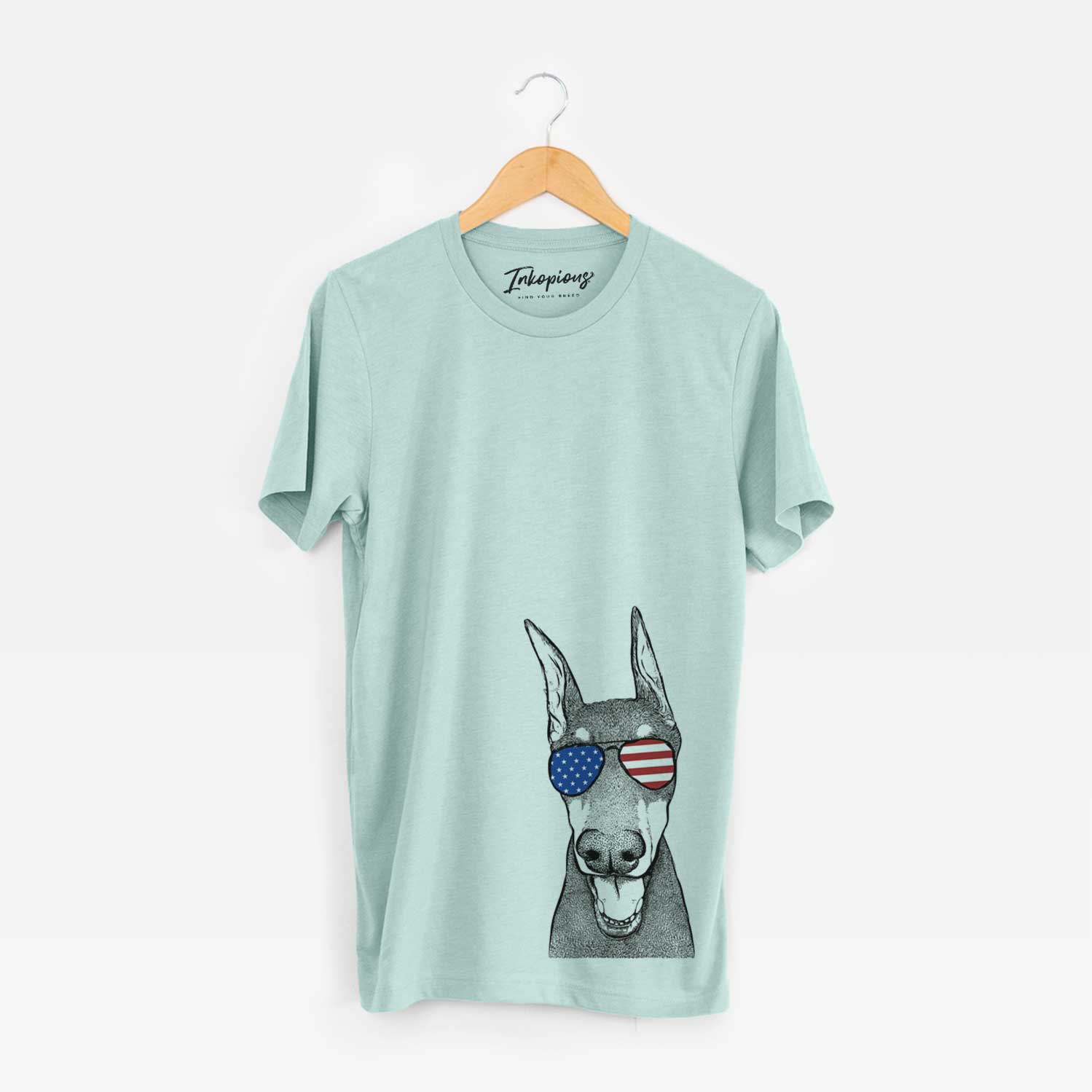 Hand-drawn sketch of Sir Duke the Doberman Pinscher wearing American flag sunglasses on a Heather Sage Unisex crewneck