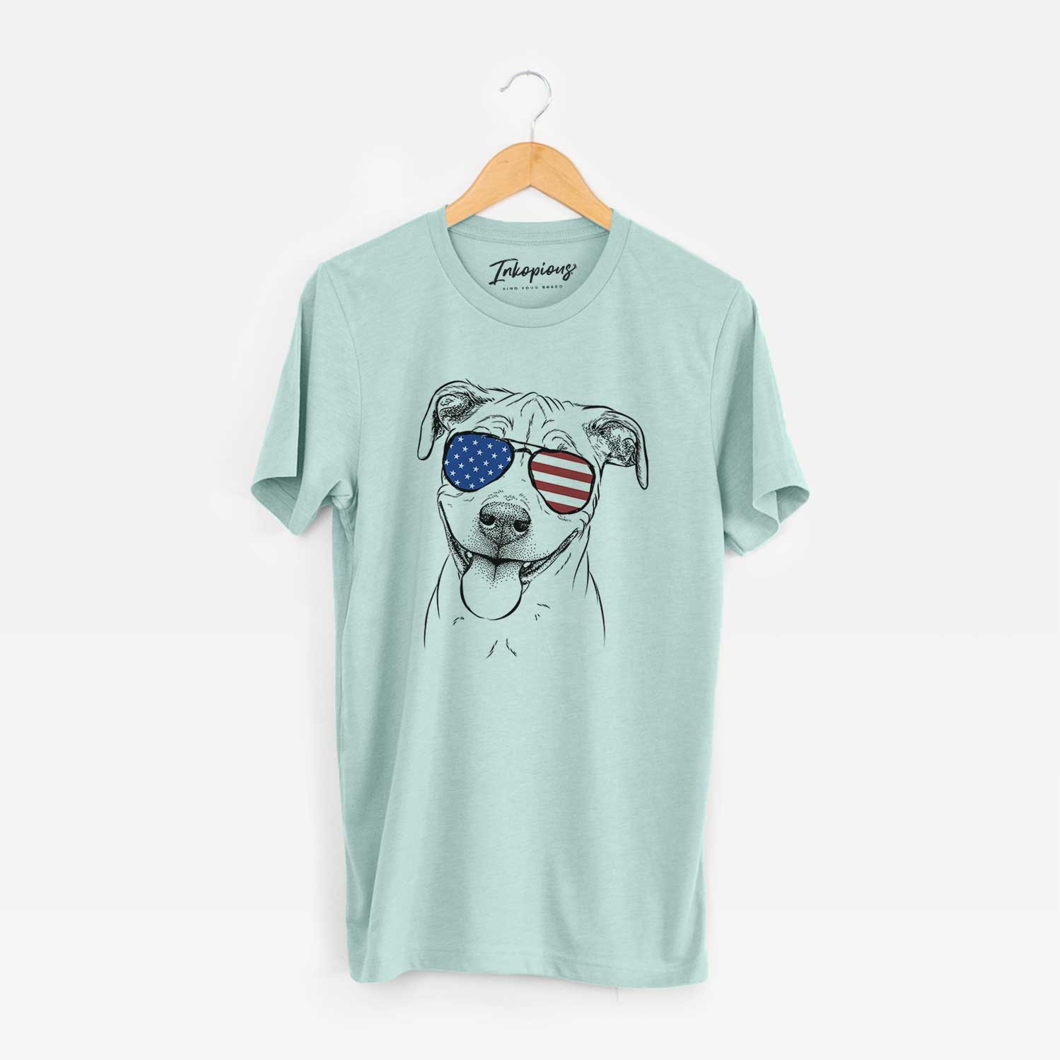 Hand-drawn sketch of Skye the Pitweiler wearing American flag sunglasses on a Heather Sage Unisex crewneck