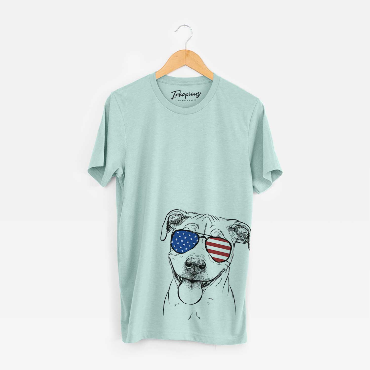 Hand-drawn sketch of Skye the Pitweiler wearing American flag sunglasses on a Heather Sage Unisex crewneck