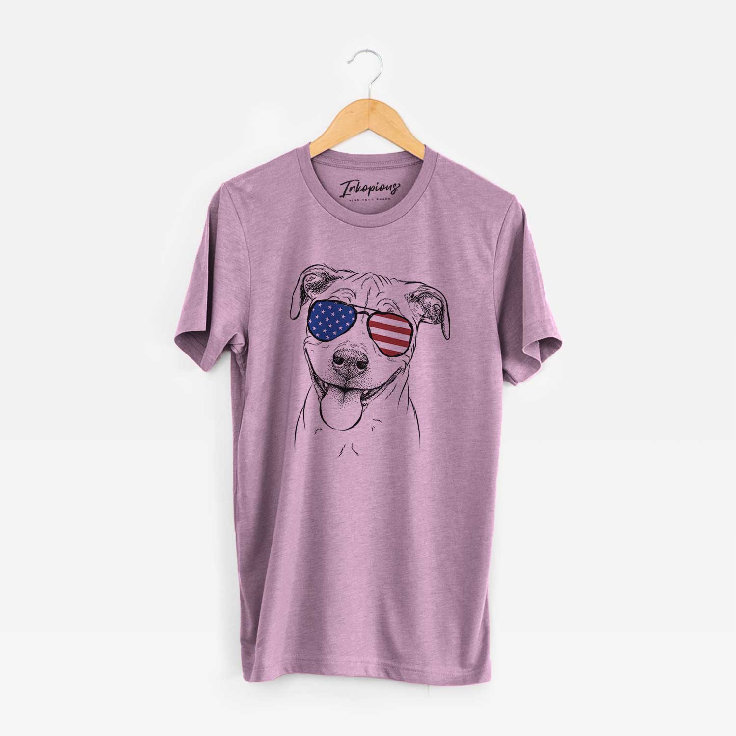 Hand-drawn sketch of Skye the Pitweiler wearing American flag sunglasses on an Orchid Unisex crewneck