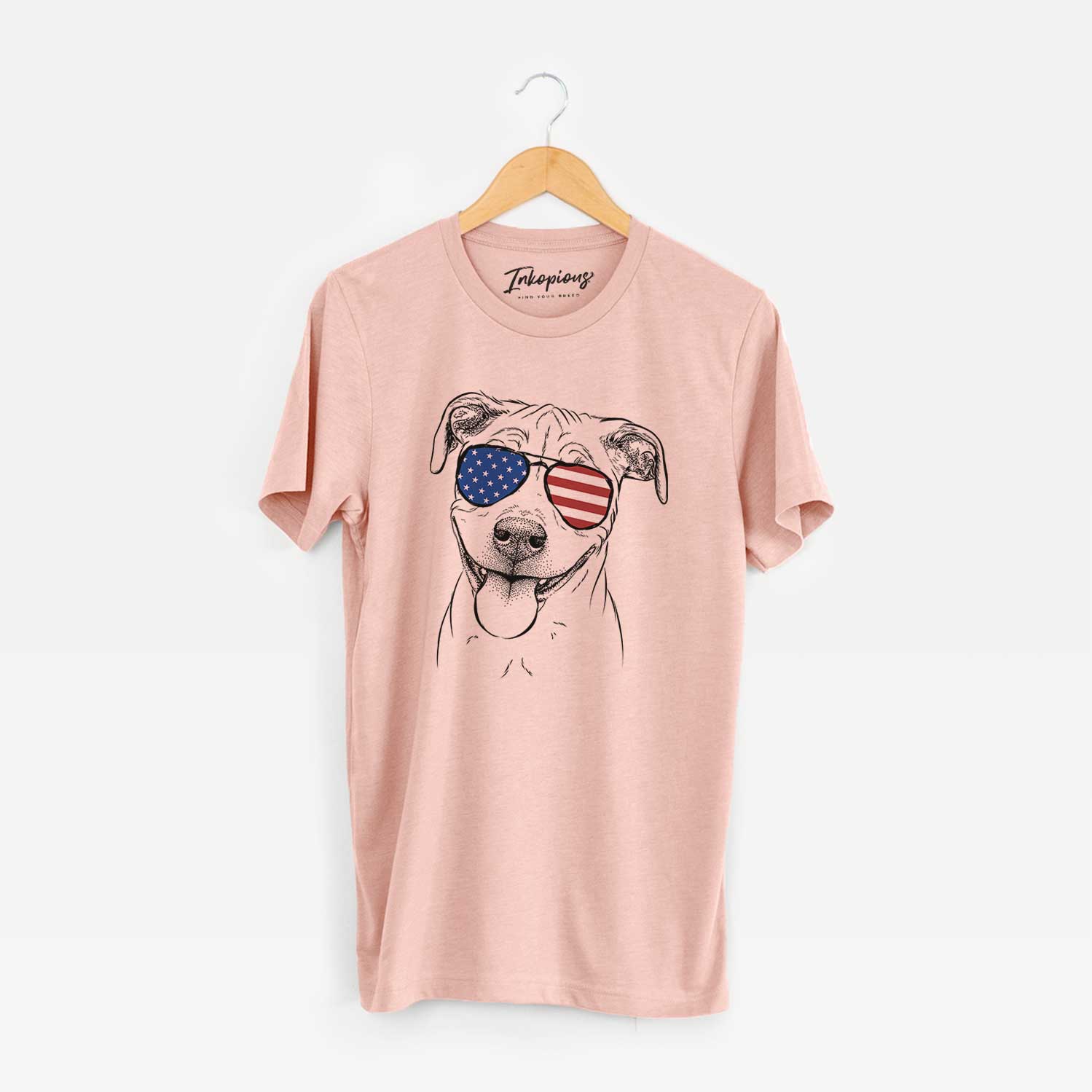 Hand-drawn sketch of Skye the Pitweiler wearing American flag sunglasses on a Peach Unisex crewneck