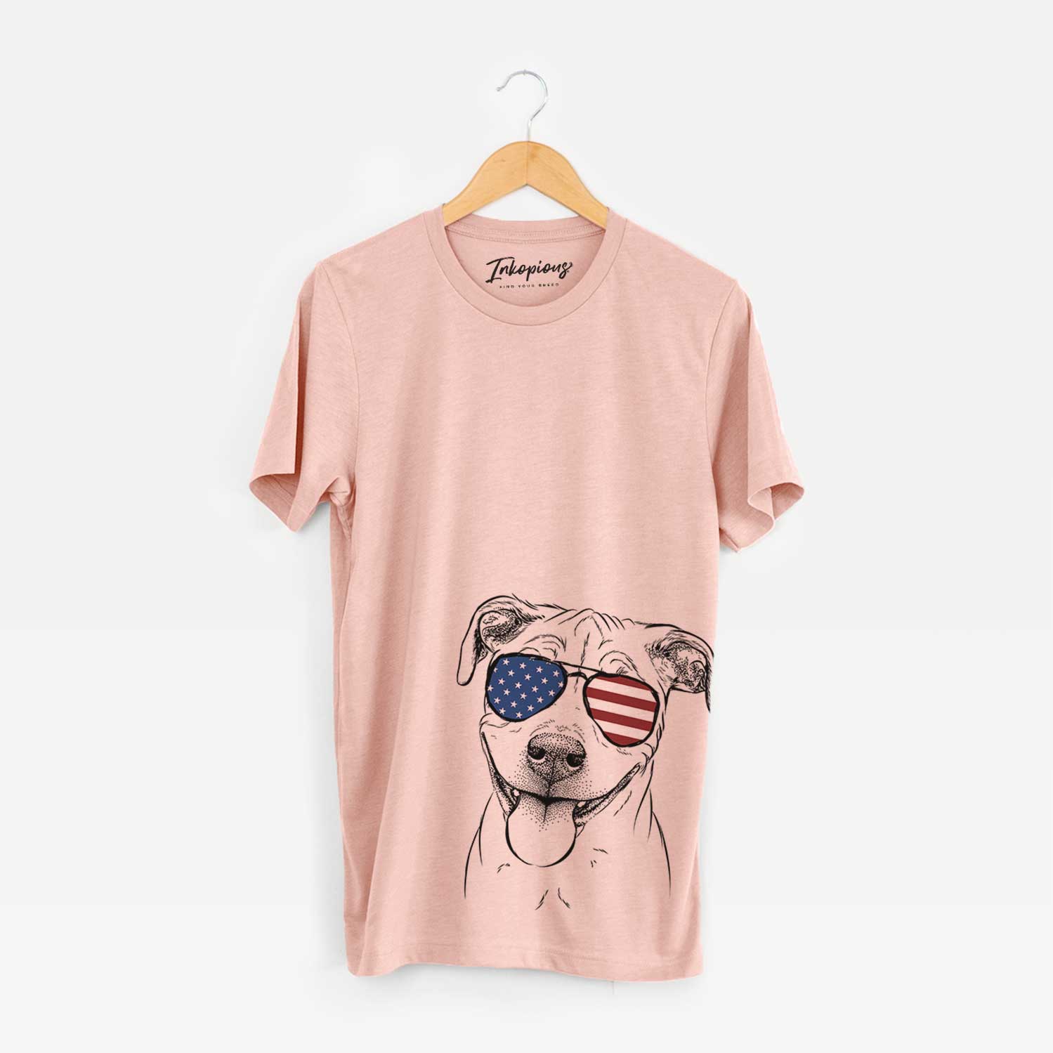 Hand-drawn sketch of Skye the Pitweiler wearing American flag sunglasses on a Peach Unisex crewneck