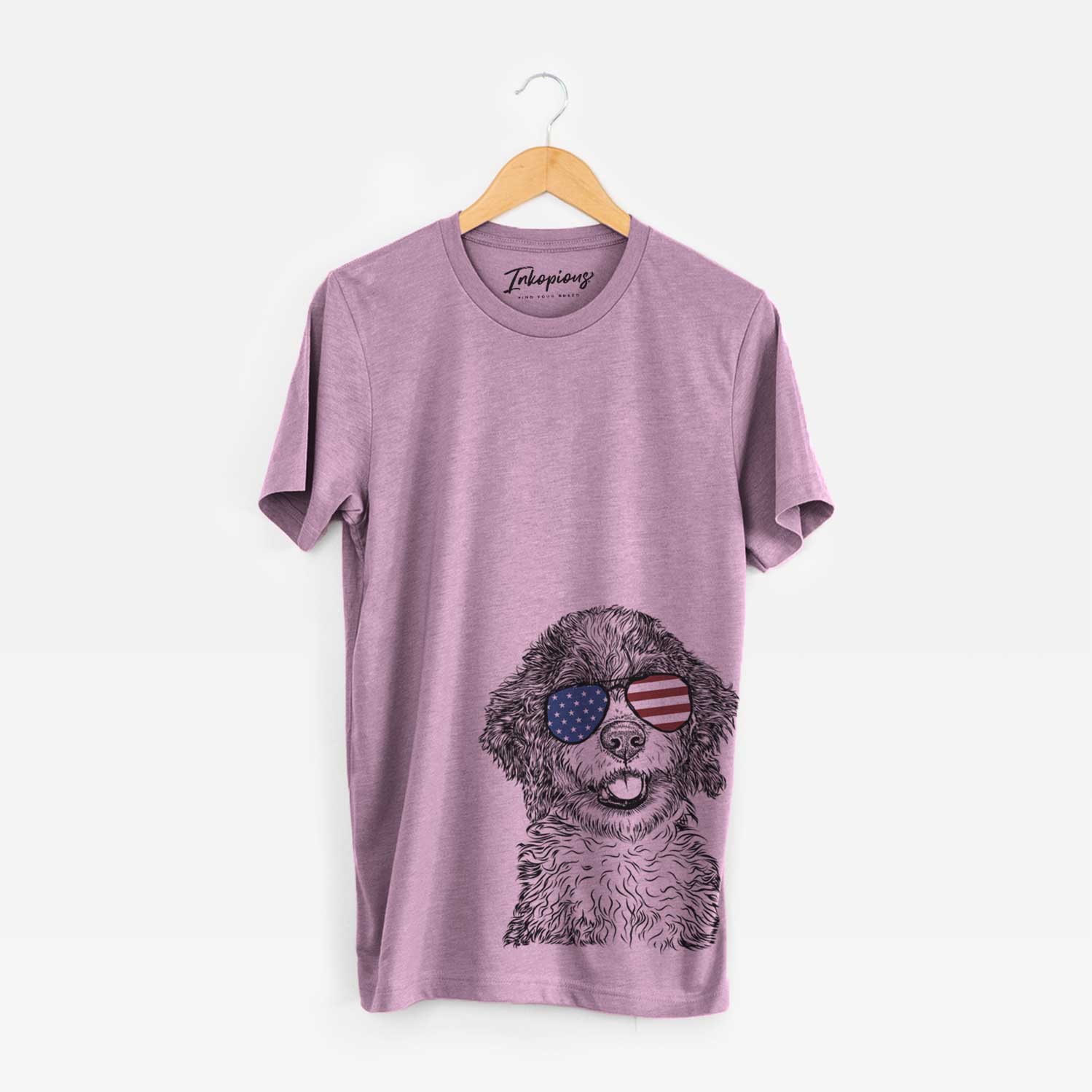 Hand-drawn sketch of Smoky the Bernedoodle Puppy wearing American flag sunglasses on an Orchid Unisex crewneck