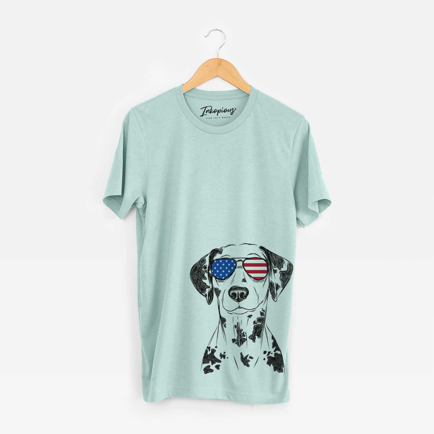 Hand-drawn sketch of Spot the Dalmatian wearing American flag sunglasses on a Heather Sage Unisex crewneck