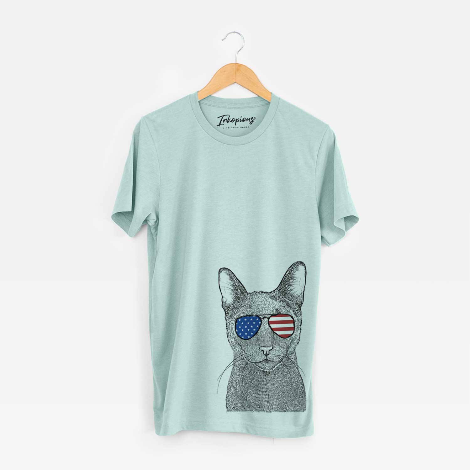 Hand-drawn sketch of Stanley the Russian Blue Cat wearing American flag sunglasses on a Heather Sage Unisex crewneck