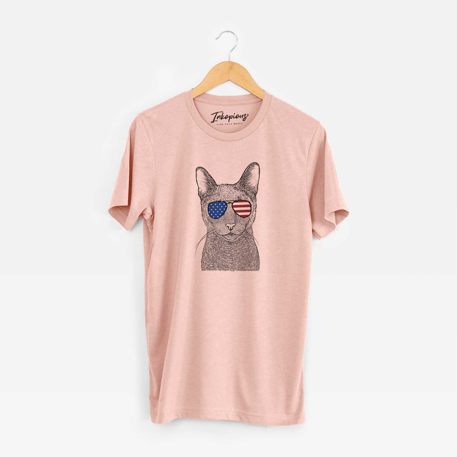 Hand-drawn sketch of Stanley the Russian Blue Cat wearing American flag sunglasses on a Peach Unisex crewneck