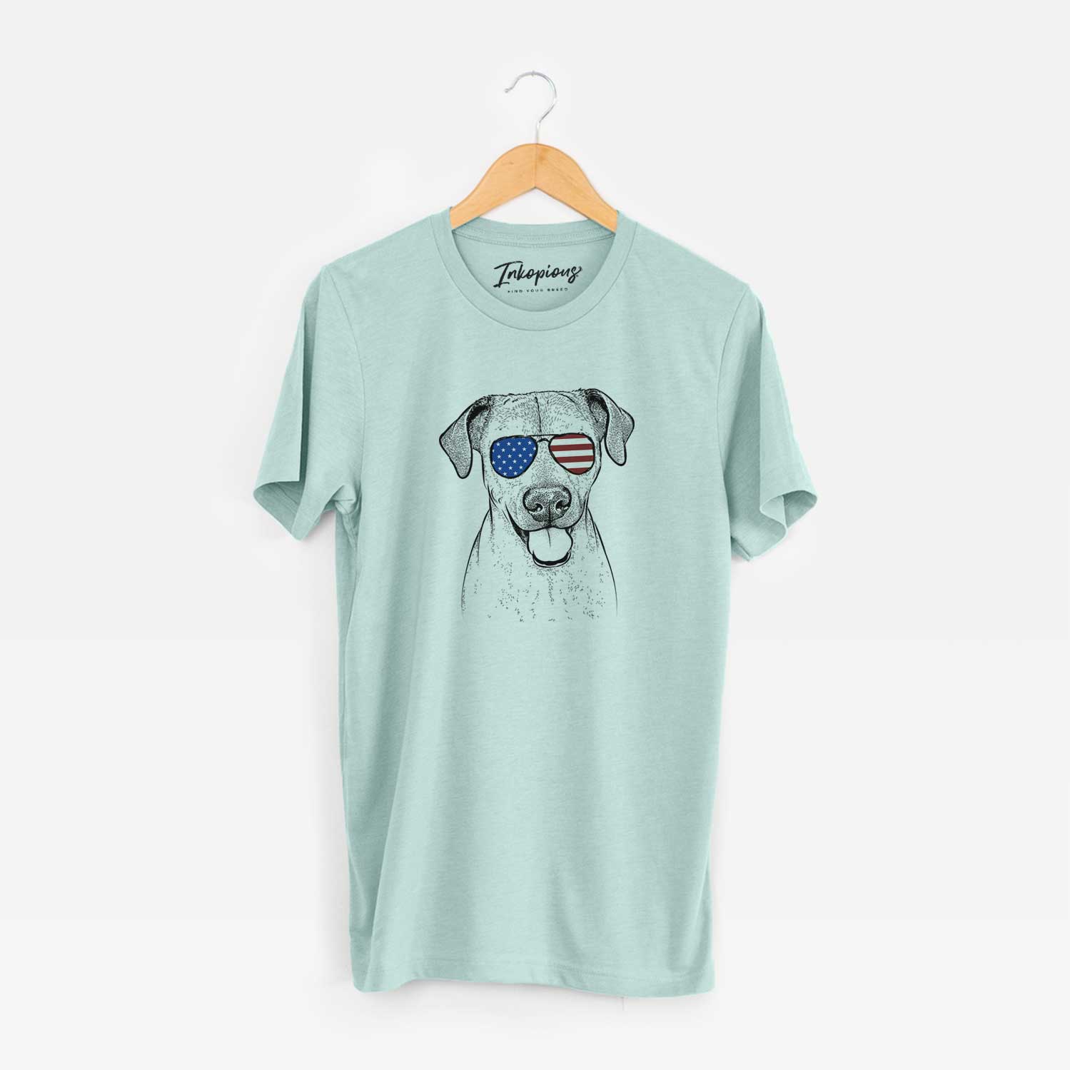 Hand-drawn sketch of Sugar the American Staffordshire Mix wearing American flag sunglasses on a Heather Sage Unisex crewneck