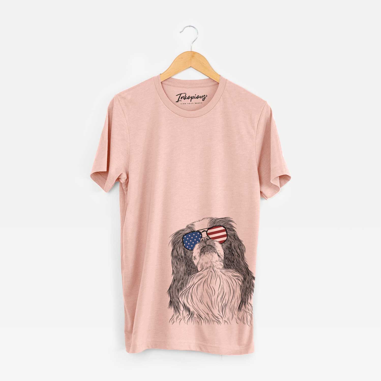 Hand-drawn sketch of Suki the Japanese Chin wearing American flag sunglasses on a Peach Unisex crewneck