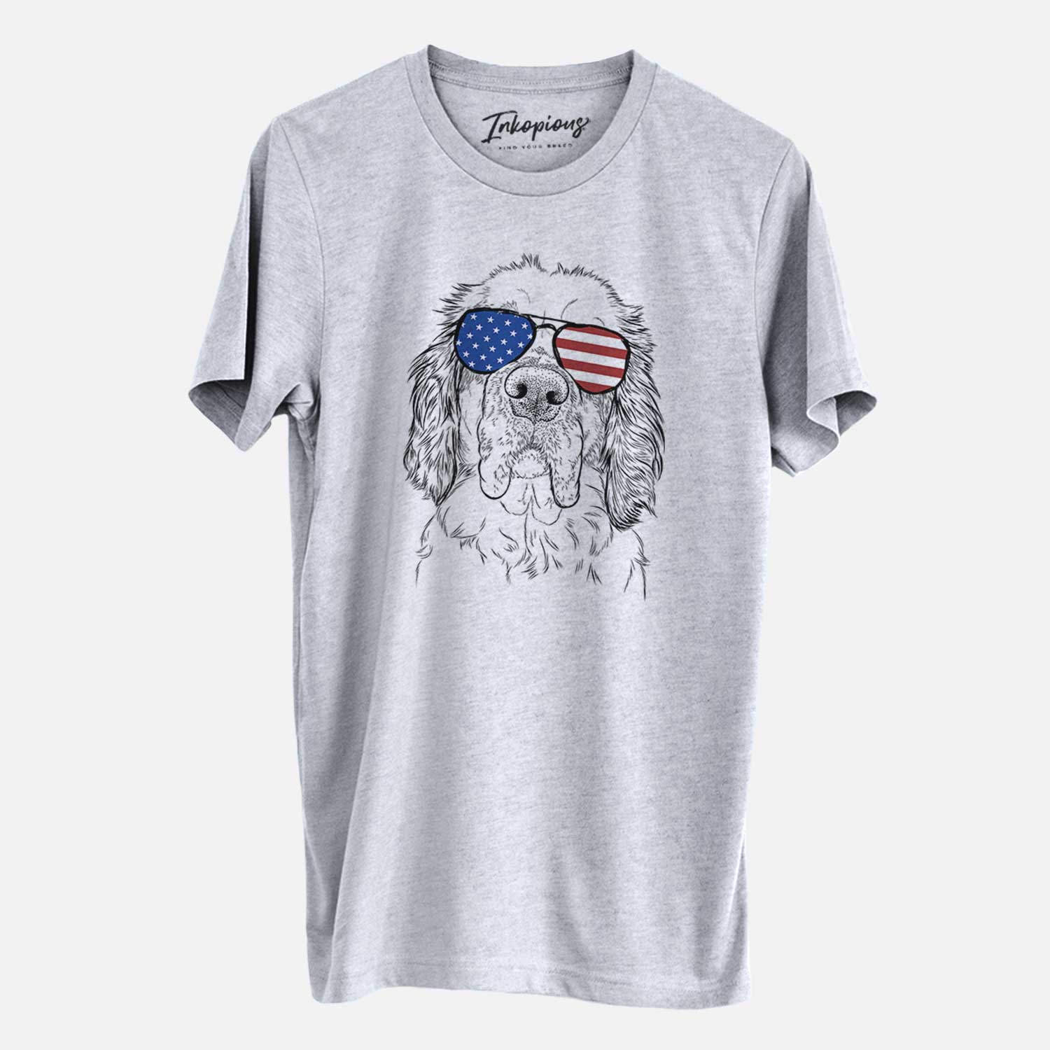 Hand-drawn sketch of Sully the Clumber Spaniel wearing American flag sunglasses on a Grey Unisex crewneck