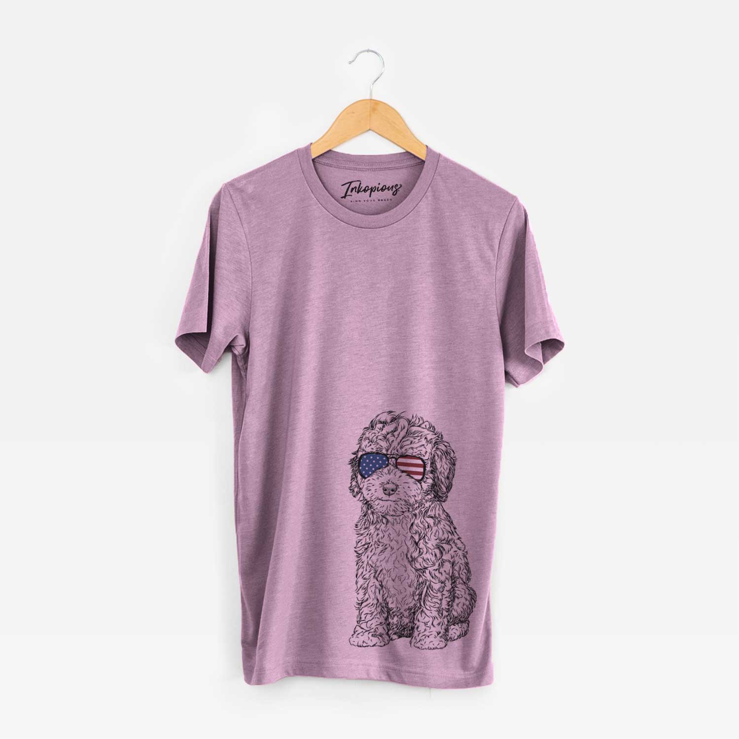 Hand-drawn sketch of Sweet Tea the Mini Doodle wearing American flag sunglasses on an Orchid Unisex crewneck