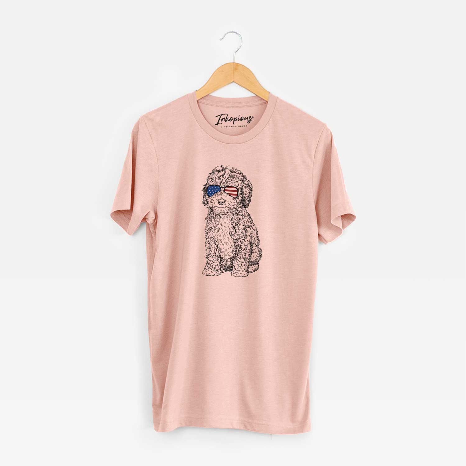 Hand-drawn sketch of Sweet Tea the Mini Doodle wearing American flag sunglasses on a Peach Unisex crewneck
