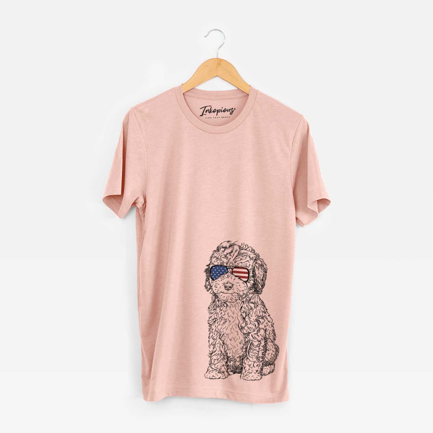 Hand-drawn sketch of Sweet Tea the Mini Doodle wearing American flag sunglasses on a Peach Unisex crewneck