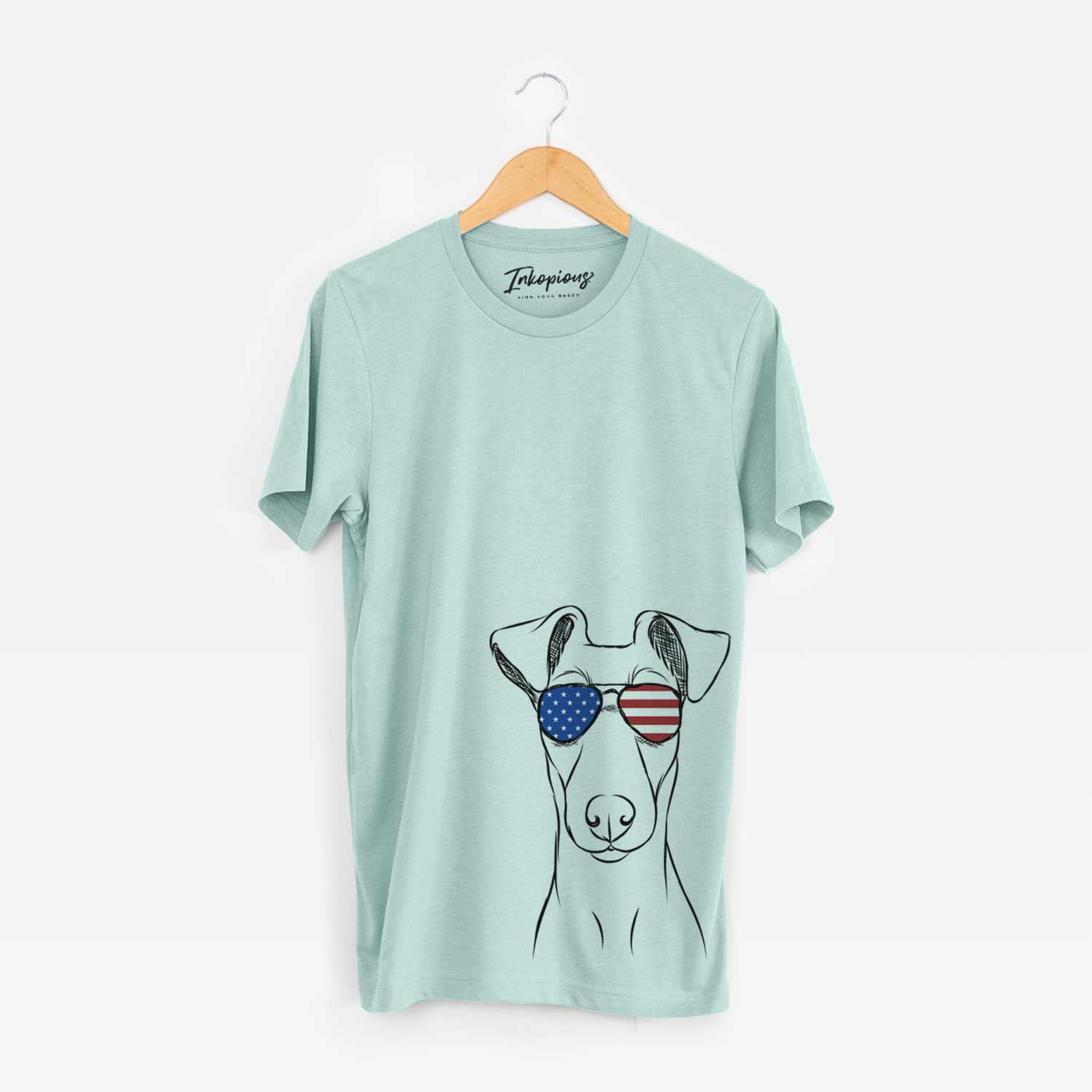 Hand-drawn sketch of Tanner the Fox Terrier wearing American flag sunglasses on a Heather Sage Unisex crewneck
