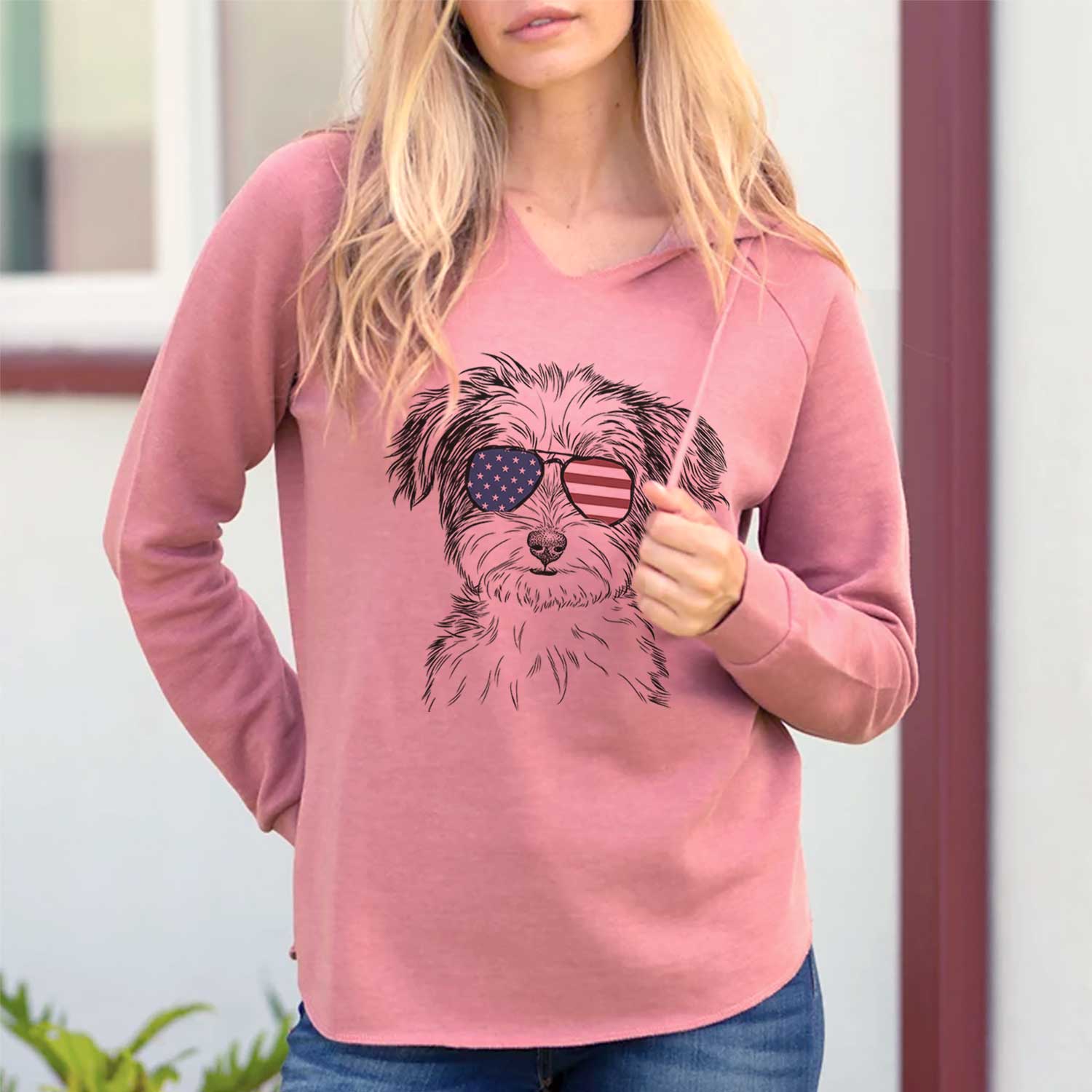 Hand-drawn sketch of Teddy the Havanese wearing American flag sunglasses on a Dusty Rose Cali Wave Hooded Sweatshirt, lifestyle photo