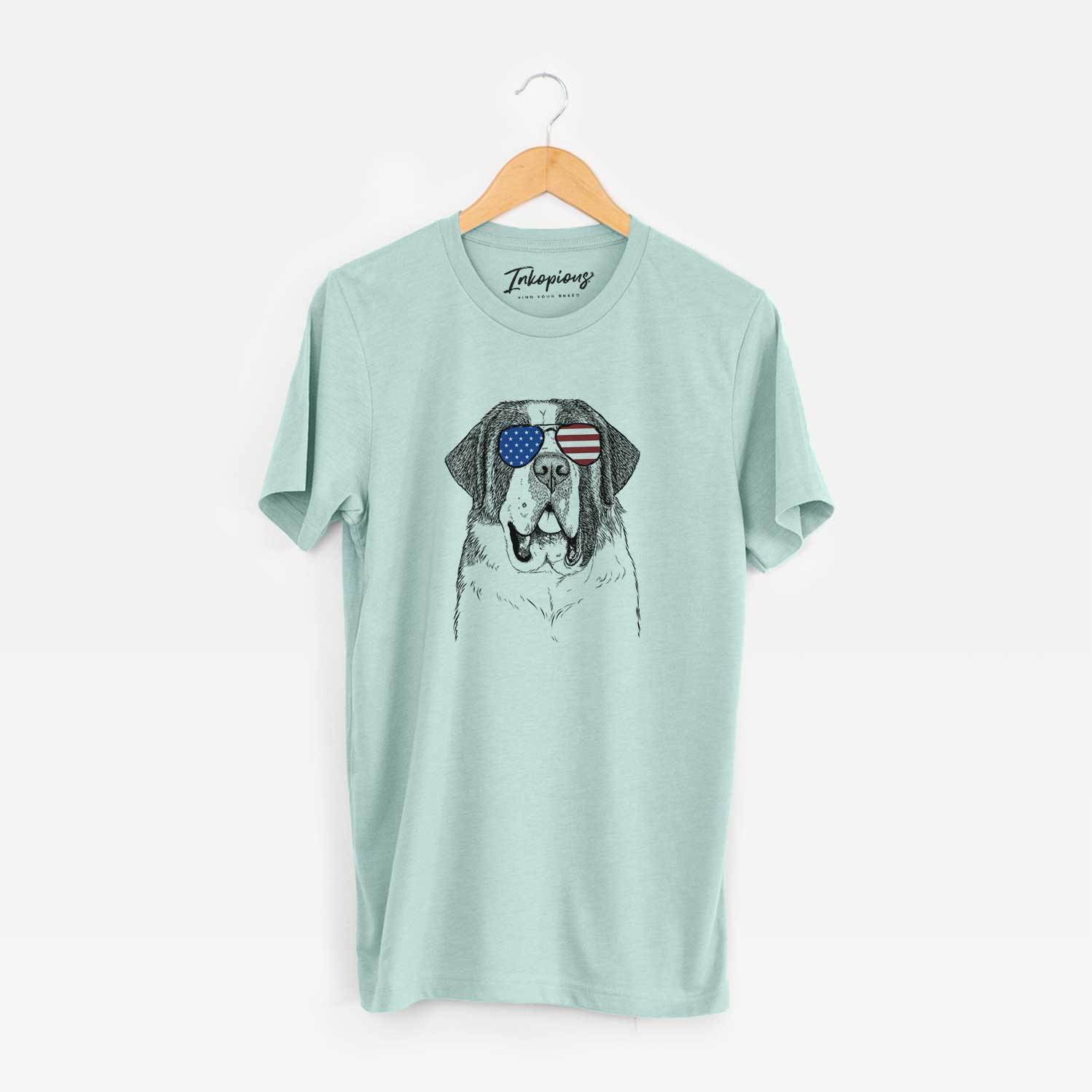 Hand-drawn sketch of Thor the Saint Bernard wearing American flag sunglasses on a Heather Sage Unisex crewneck