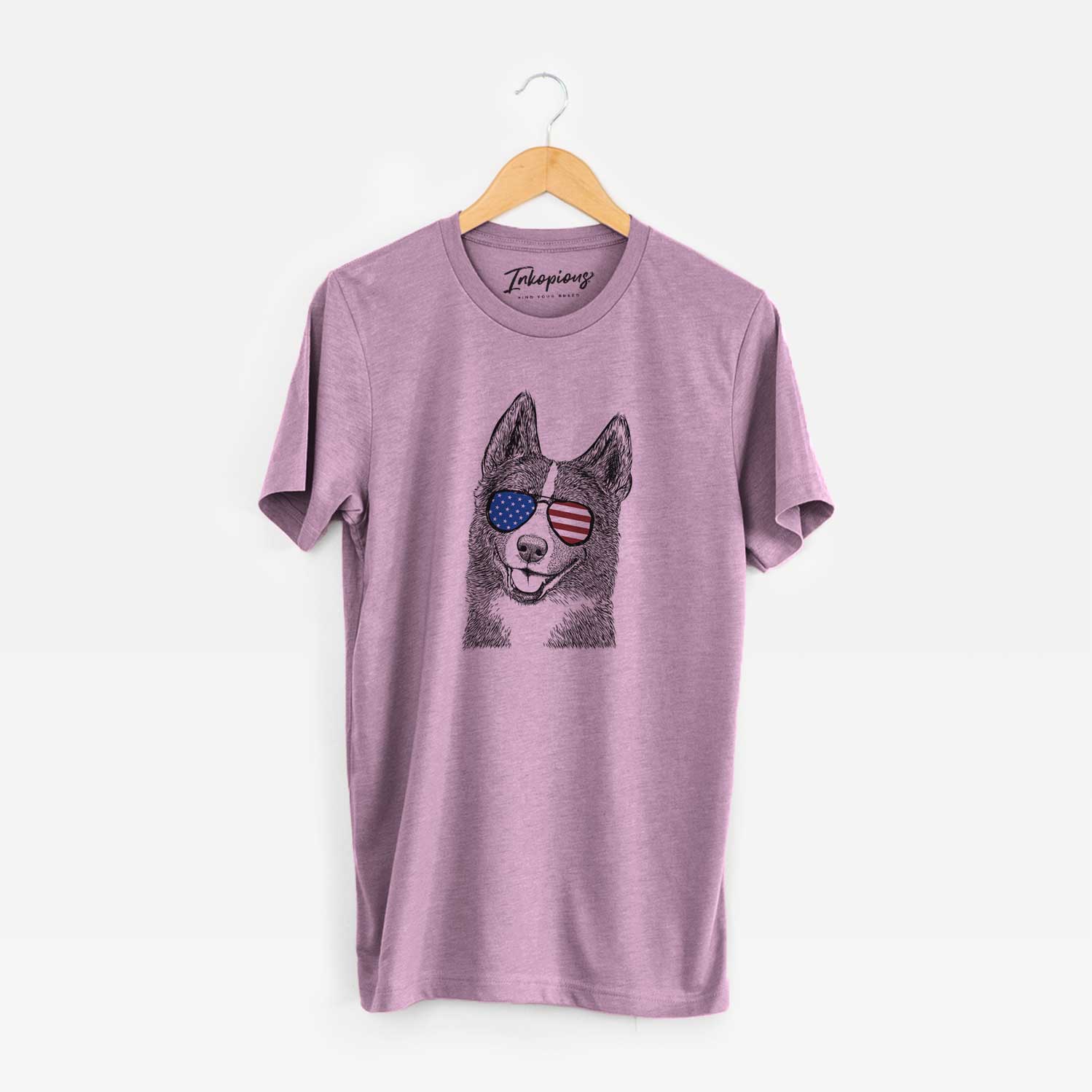 Hand-drawn sketch of Tosca the Karelian Bear Dog wearing American flag sunglasses on an Orchid Unisex crewneck