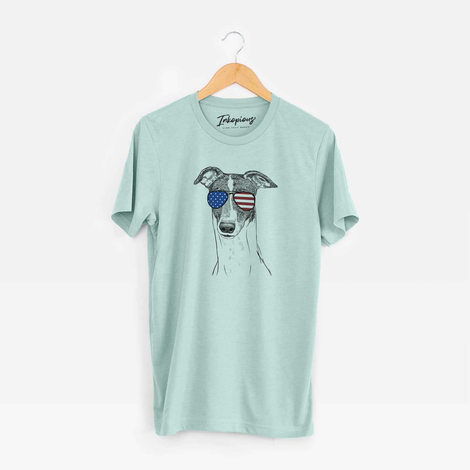 Hand-drawn sketch of Vyncent the Greyhound wearing American flag sunglasses on a Heather Sage Unisex crewneck