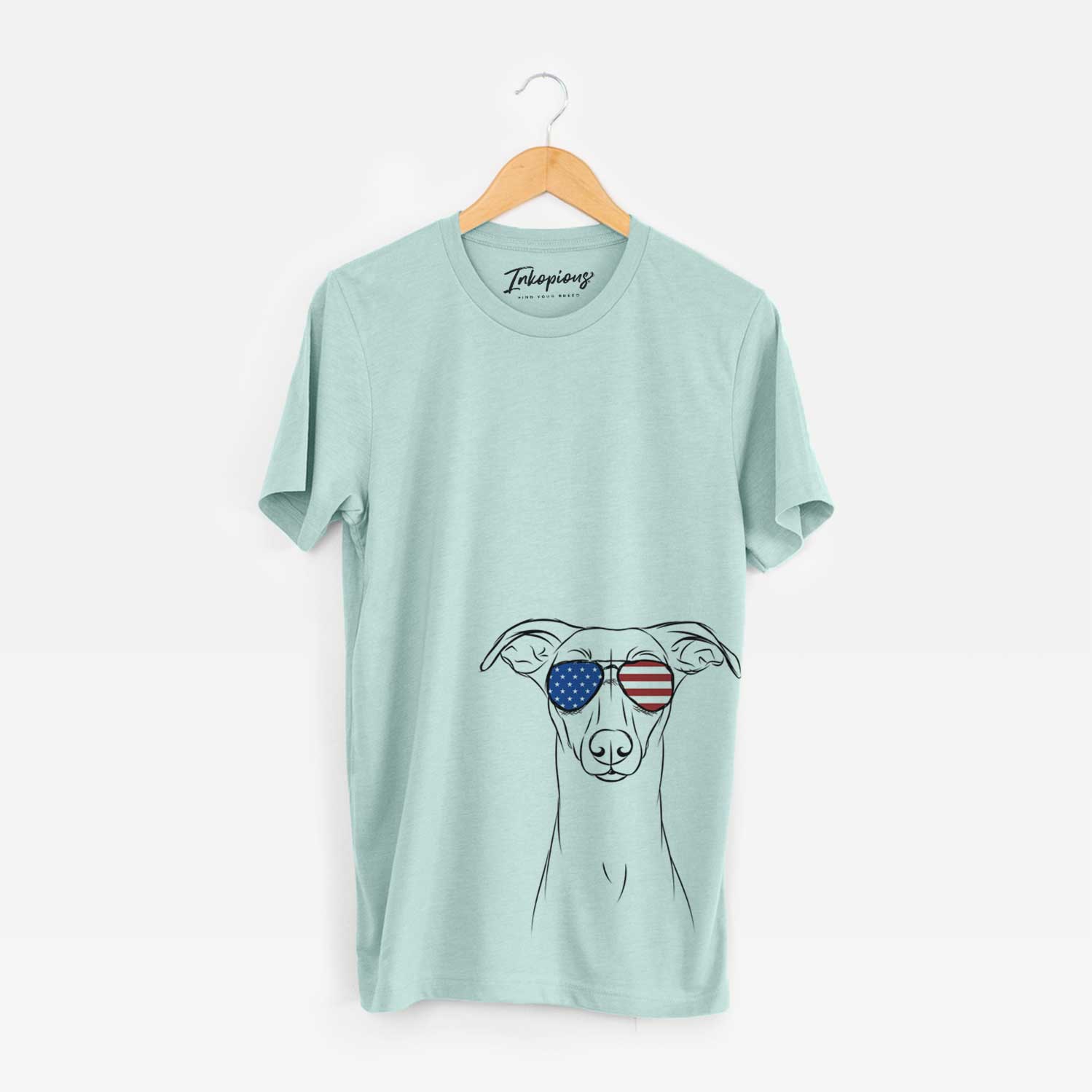 Hand-drawn sketch of Wallace the Whippet wearing American flag sunglasses on a Heather Sage Unisex crewneck